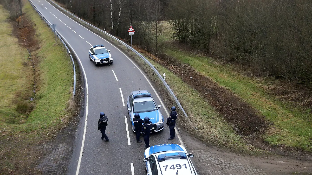 Police officers secure the area on a road near the site where two German police officers were fatally shot early January 31, 2022, during a routine traffic stop near Kusel, southwestern Germany, January 31, 2022. REUTERS/Thilo Schmuelgen