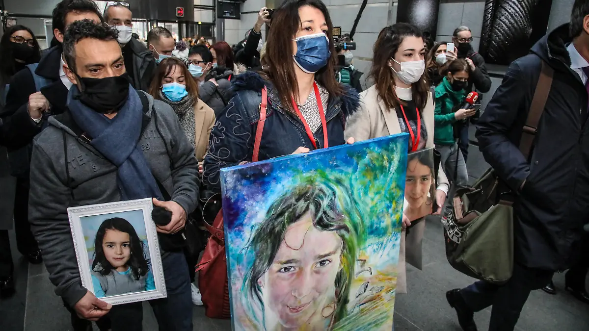 Joachim de Araujo (L), Jennifer Cleyet-Marrel (C), parents of Maelys, and Colleen de Araujo (R), sister of Maelys, hold pictures of the eight-year-old girl as they arrive at the Grenoble assize courthouse, eastern France, on January 31, 2022, for the trial of Nordahl Lelandais accused of the August 2017 abduction and murder of Maelys de Araujo, who disappeared during a wedding. Photo by Erik Sampers/ABACAPRESS.COM
