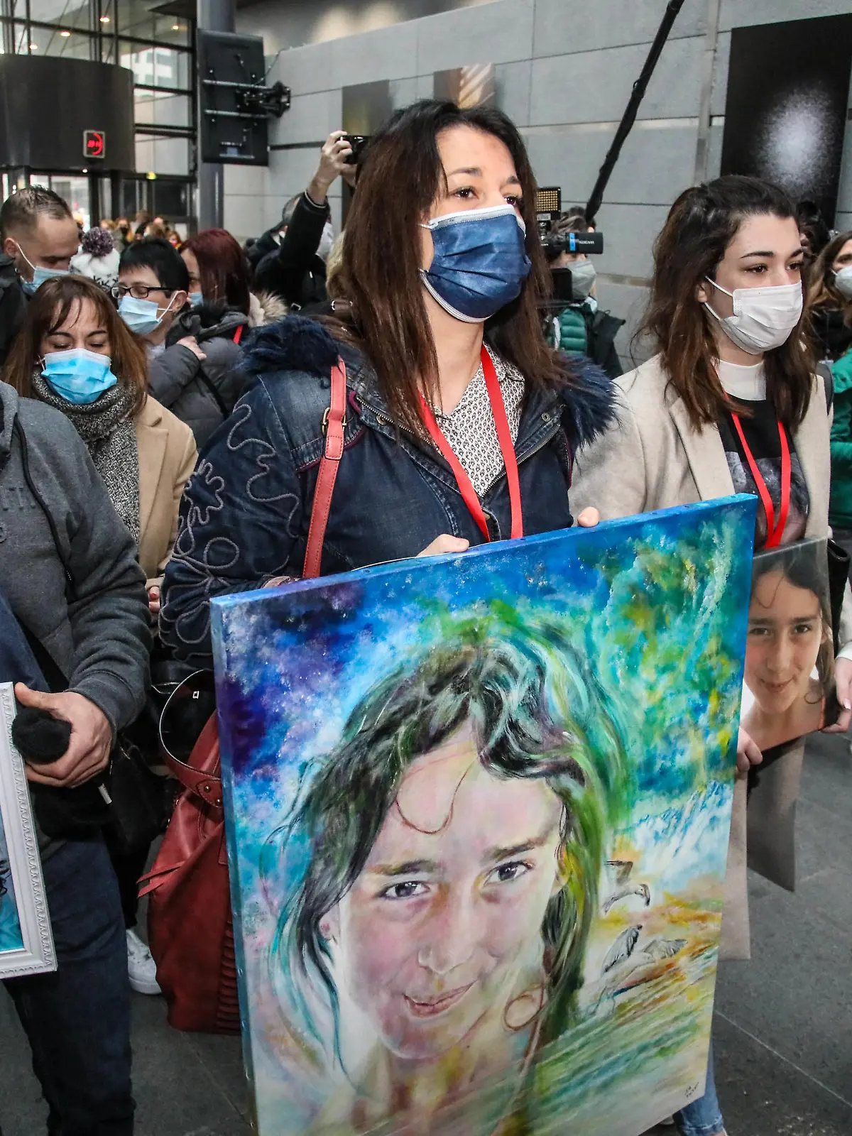 Joachim de Araujo (L), Jennifer Cleyet-Marrel (C), parents of Maelys, and Colleen de Araujo (R), sister of Maelys, hold pictures of the eight-year-old girl as they arrive at the Grenoble assize courthouse, eastern France, on January 31, 2022, for the trial of Nordahl Lelandais accused of the August 2017 abduction and murder of Maelys de Araujo, who disappeared during a wedding. Photo by Erik Sampers/ABACAPRESS.COM