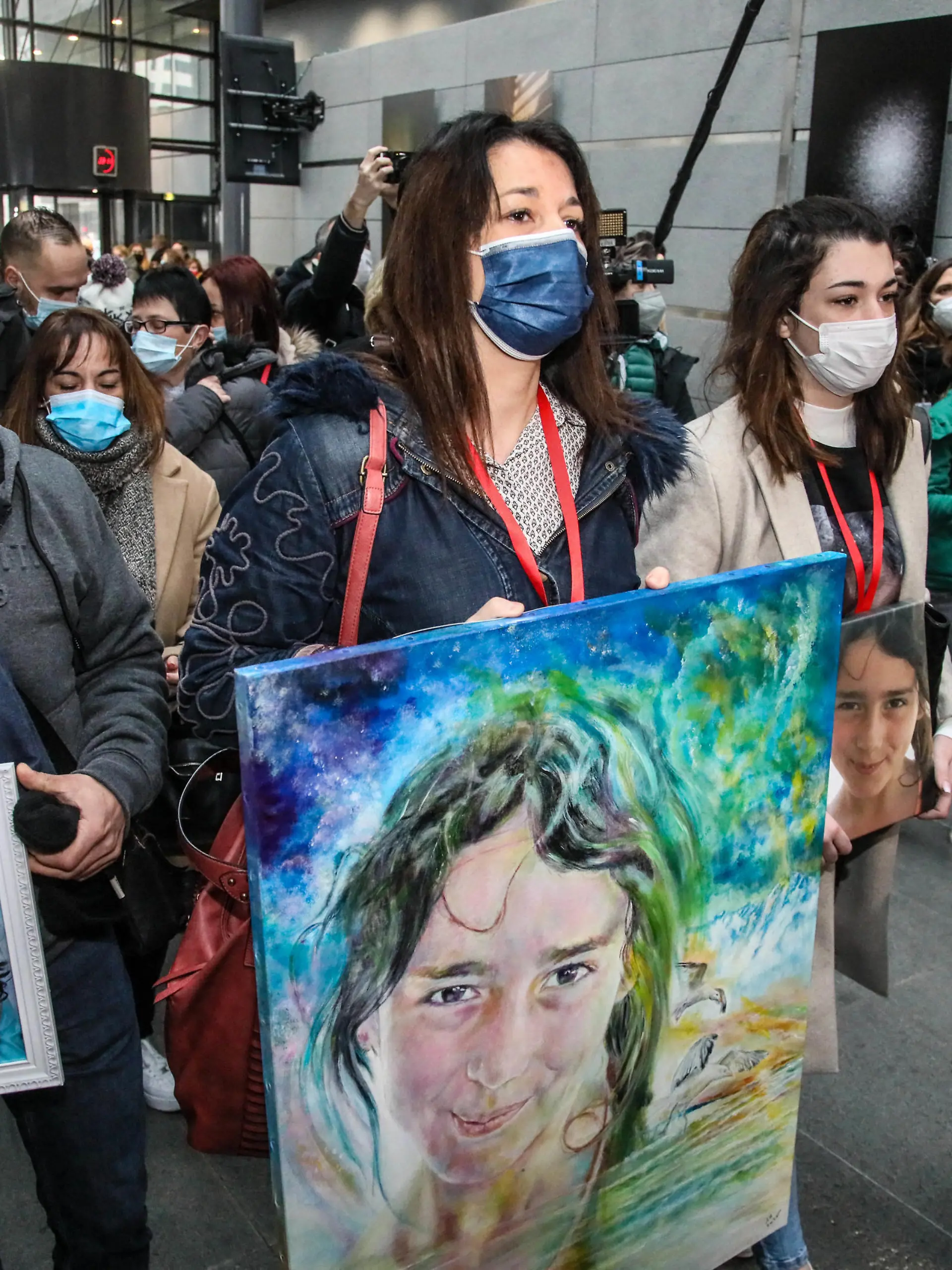 Joachim de Araujo (L), Jennifer Cleyet-Marrel (C), parents of Maelys, and Colleen de Araujo (R), sister of Maelys, hold pictures of the eight-year-old girl as they arrive at the Grenoble assize courthouse, eastern France, on January 31, 2022, for the trial of Nordahl Lelandais accused of the August 2017 abduction and murder of Maelys de Araujo, who disappeared during a wedding. Photo by Erik Sampers/ABACAPRESS.COM