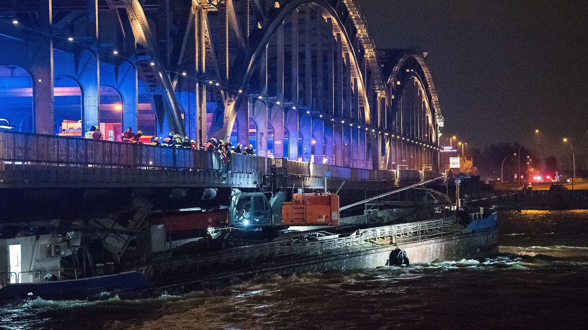 29.01.2022, Hamburg: Ein Binnenschiff hängt unter der Freihafenelbbrücke fest. Beim Durchfahren der Brücke im starken Sturm war das Schiff mit dem Steuerhaus an der Brücke hängengeblieben und hat sich dabei verklemmt. Foto: Daniel Bockwoldt/dpa +++ dpa-Bildfunk +++