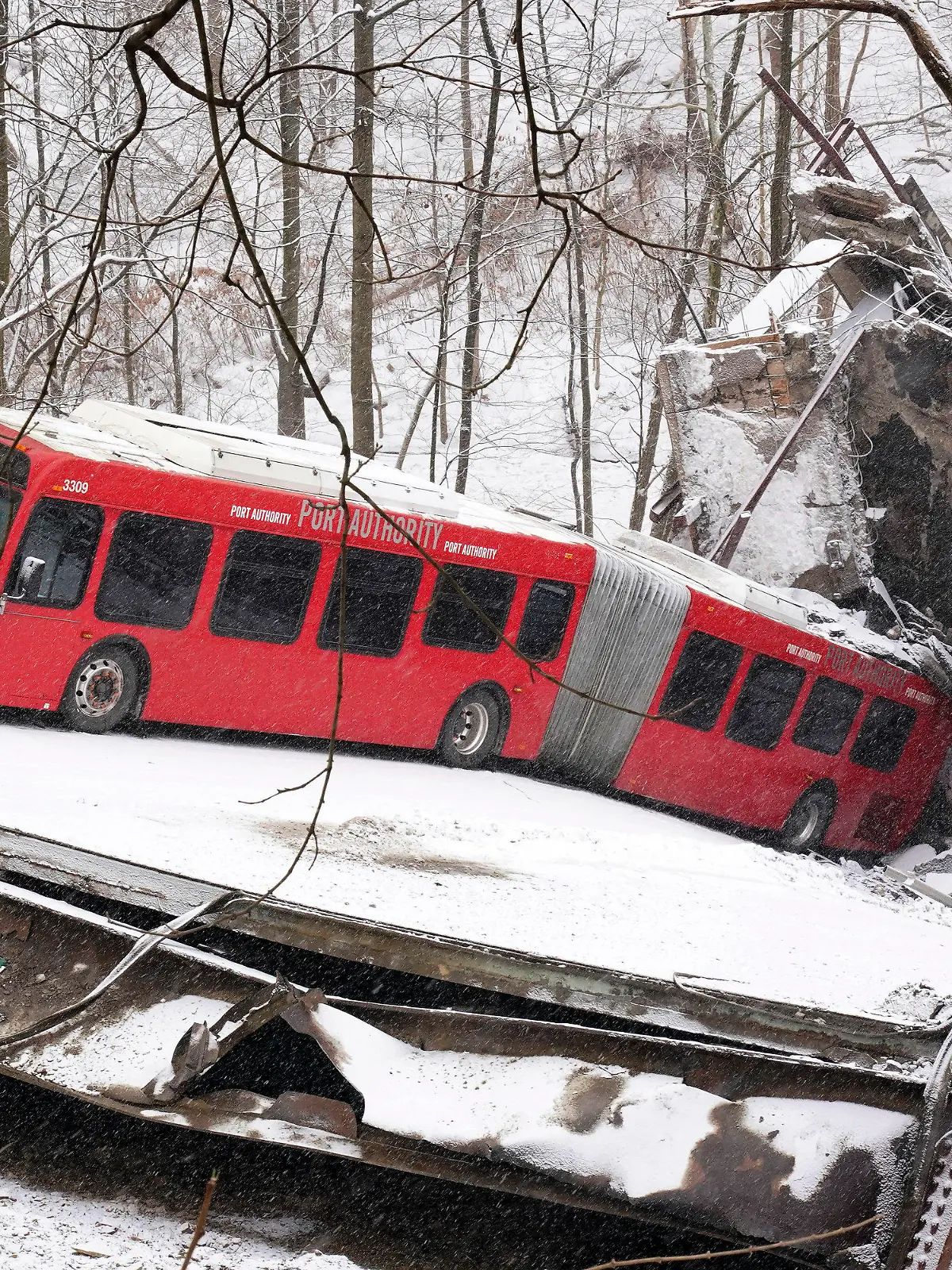 This is a Pittsburgh Transit Authority bus that was on the Fern Hollow Bridge in Pittsburgh when it collapsed Friday morning Friday, Jan. 28, 2022. (AP Photo/Gene J. Puskar)