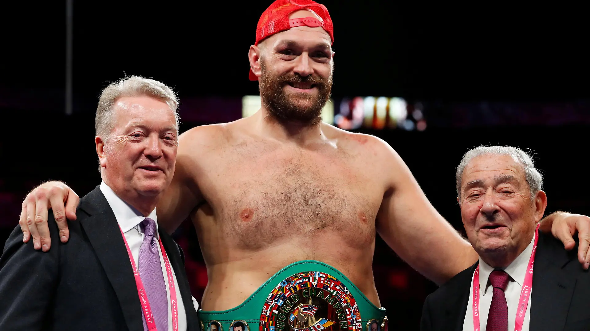 FILE PHOTO: Boxing - Tyson Fury v Deontay Wilder - WBC Heavyweight Title - T-Mobile Arena, Las Vegas, Nevada, U.S. - October 9, 2021 Tyson Fury poses for a photograph with promoters Frank Warren and Bob Arum during a press conference after winning the fight against Deontay Wilder REUTERS/Steve Marcus/File Photo