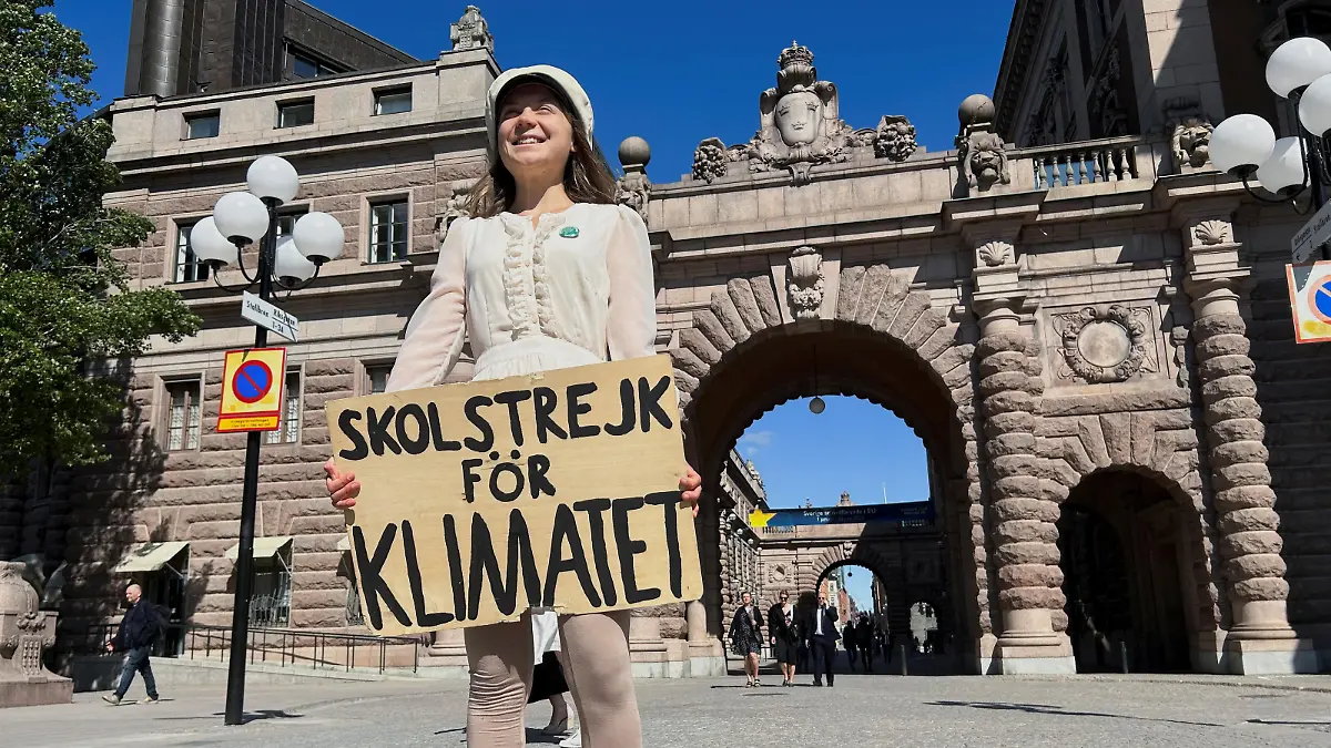 Greta Thunberg stands with a sign that reads, "School Strike for climate", outside the Swedish Parliament on the day of her weekly protest in Stockholm, Sweden, June 9, 2023. REUTERS/Marie Mannes