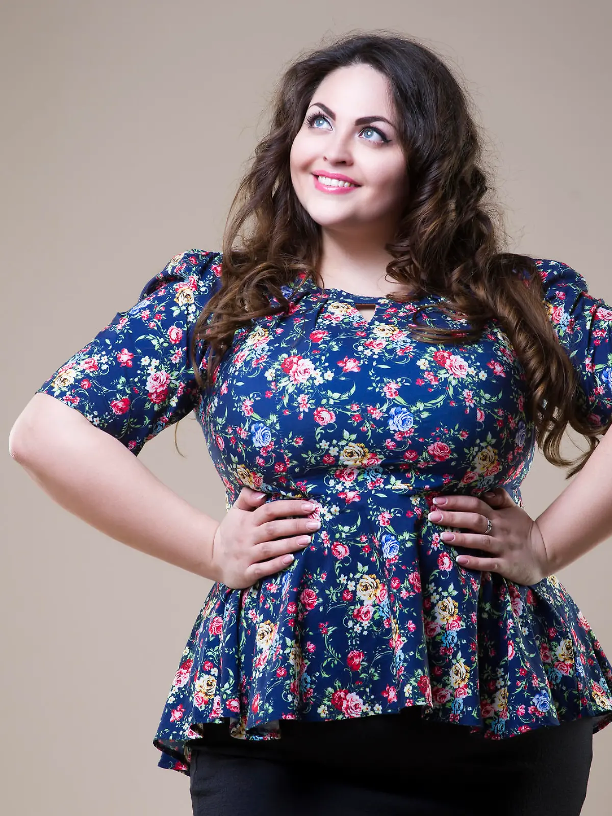 Plus size fashion model in casual clothes, fat woman on beige studio background, overweight female body, professional make-up and hairstyle