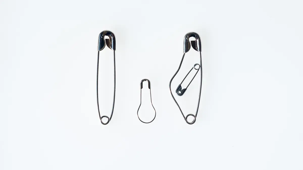 Simbol of a Family made with safety pins with pregned moter, father and son