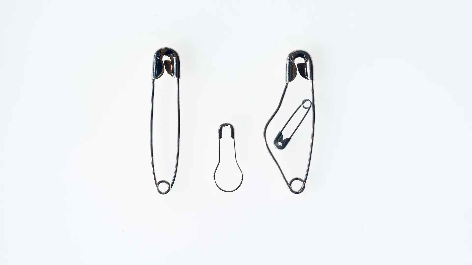 Simbol of a Family made with safety pins with pregned moter, father and son