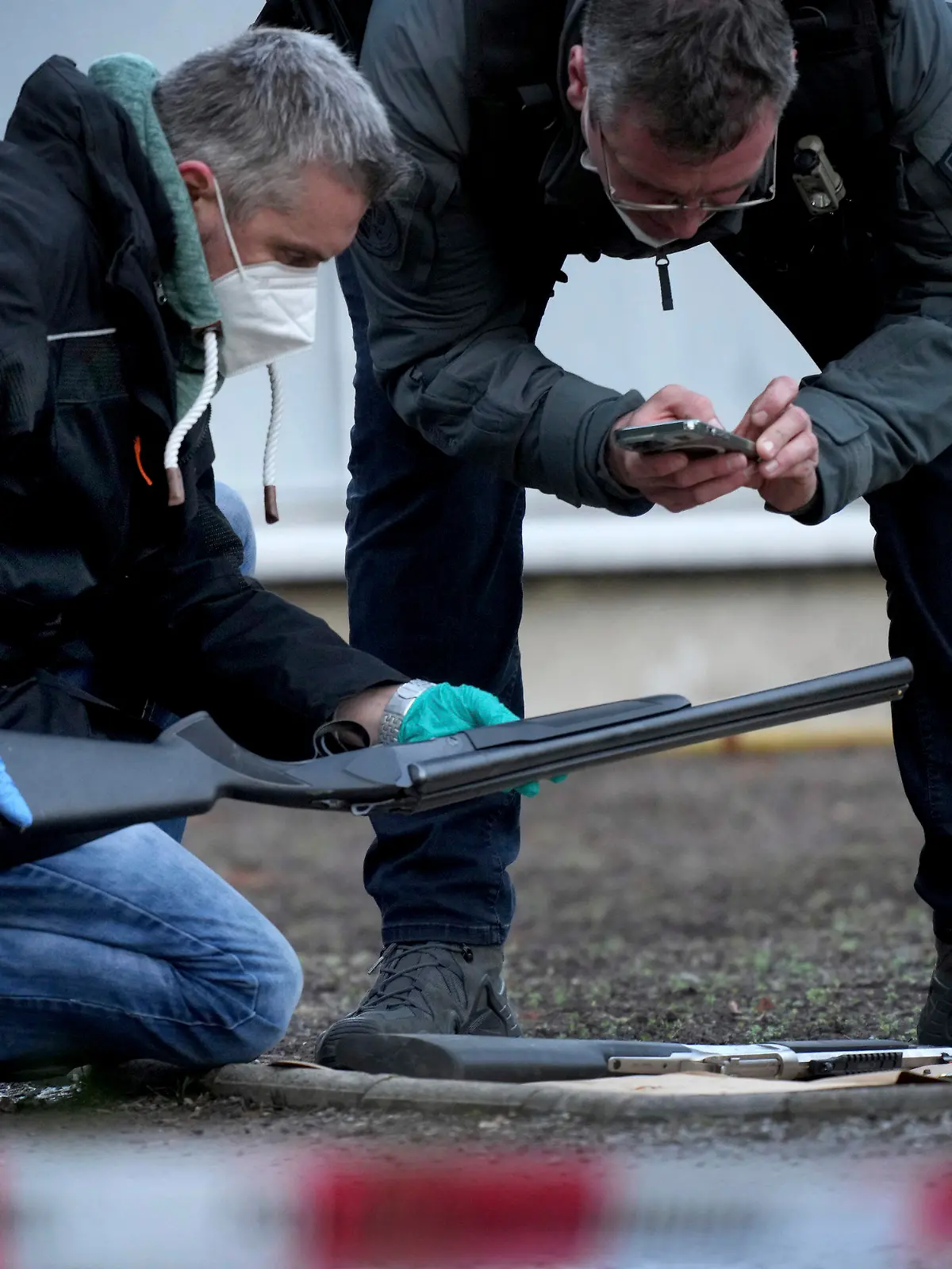 Police officers secure traces on the grounds of the Heidelberg University Botanical Garden in Heidelberg, Germany, Monday, Jan. 24, 2022. German police say a lone gunman wounded several people at a lecture theatre in the southwest city of Heidelberg on Monday. Police said in a brief statement that the perpetrator was dead but didn't give details of how that happened.(AP Photo/Michael Probst)