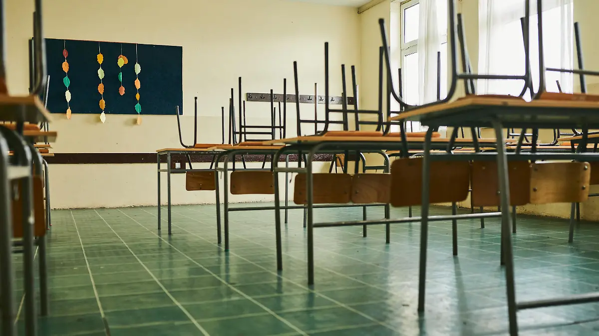 Empty classroom with chairs on the table during COVID-19 pandemic
