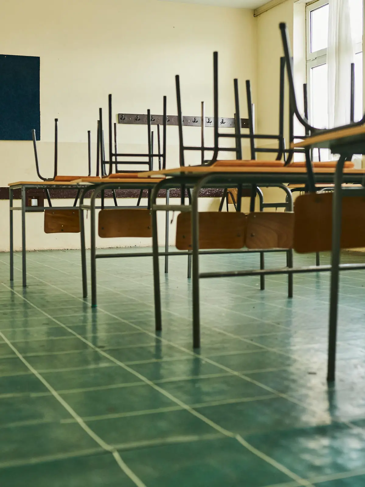 Empty classroom with chairs on the table during COVID-19 pandemic