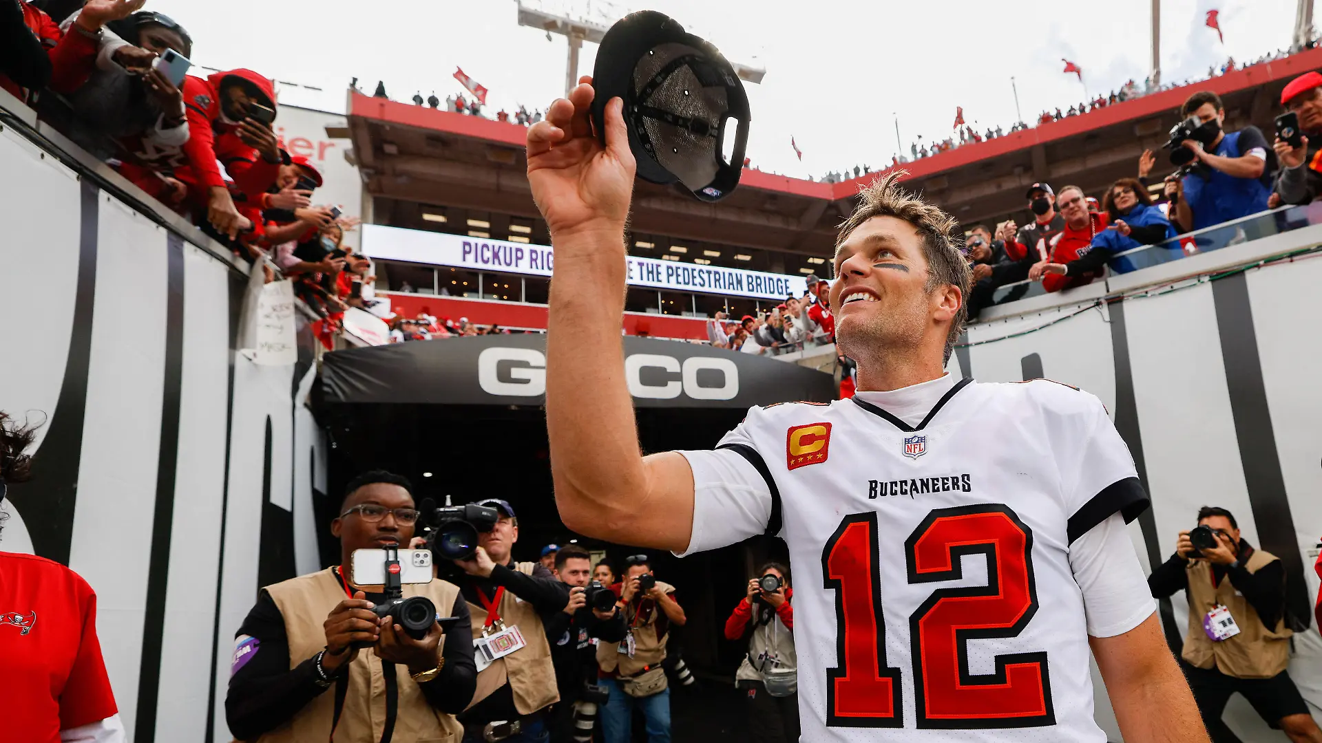Jan 16, 2022; Tampa, Florida, USA; Tampa Bay Buccaneers quarterback Tom Brady (12) greets fans after beating the Philadelphia Eagles 31-15 in a NFC Wild Card playoff football game at Raymond James Stadium. Mandatory Credit: Nathan Ray Seebeck-USA TODAY Sports