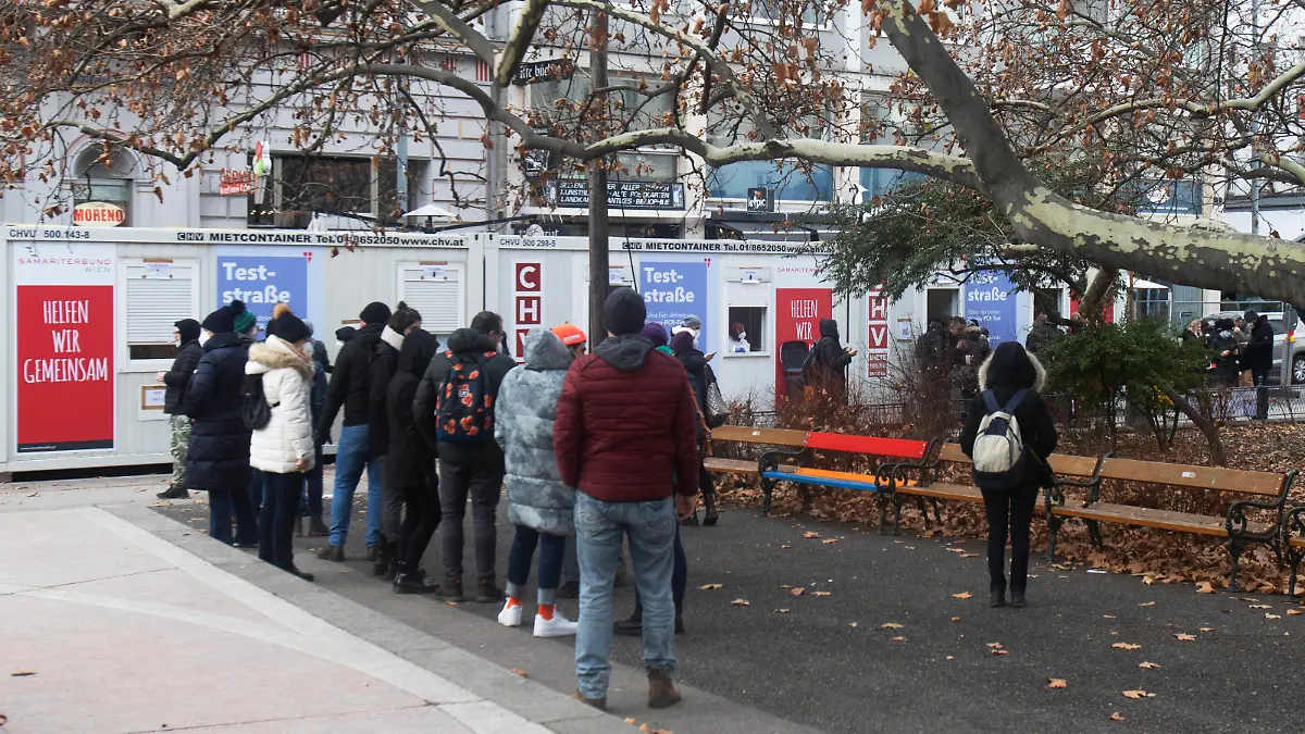 AUSTRIA - VIENNA - VIRUS - HEALTH People stand in the line in front of the test container in the Corona virus COVID-19 PCR test street in downtown Vienna on December 27, 2021. The City of Vienna is offering free PCR tests to all people. /// Menschen stehen in der Schlage vor dem Testcontainer in der Corona virus COVID-19 PCR Teststrasse in der Innenstadt in Wien am 27. Dezember 2021. Die Stadt Wien bietet allen Menschen kostenlose PCR Test an. *** AUSTRIA VIENNA VIRUS HEALTH People stand in the line in front of the test container in the Corona virus COVID 19 PCR test street in downtown Vienna on December 27, 2021 The City of Vienna is offering free PCR tests to all people People stand in the line in front of the test container in th PUBLICATIONxNOTxINxAUT