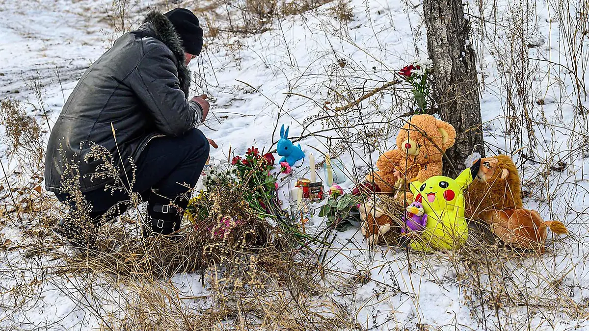 Girl, 7, daughter of decorated military pilot hero, was mauled to death by a pack of stray dogs on January 22, 2022 as she walked home from music school.
Domna village residents bring toys, flowers and candles to the place of tragedy