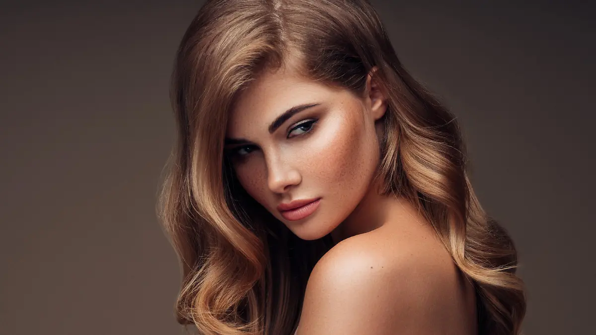 Young beautiful model with long wavy well groomed hair