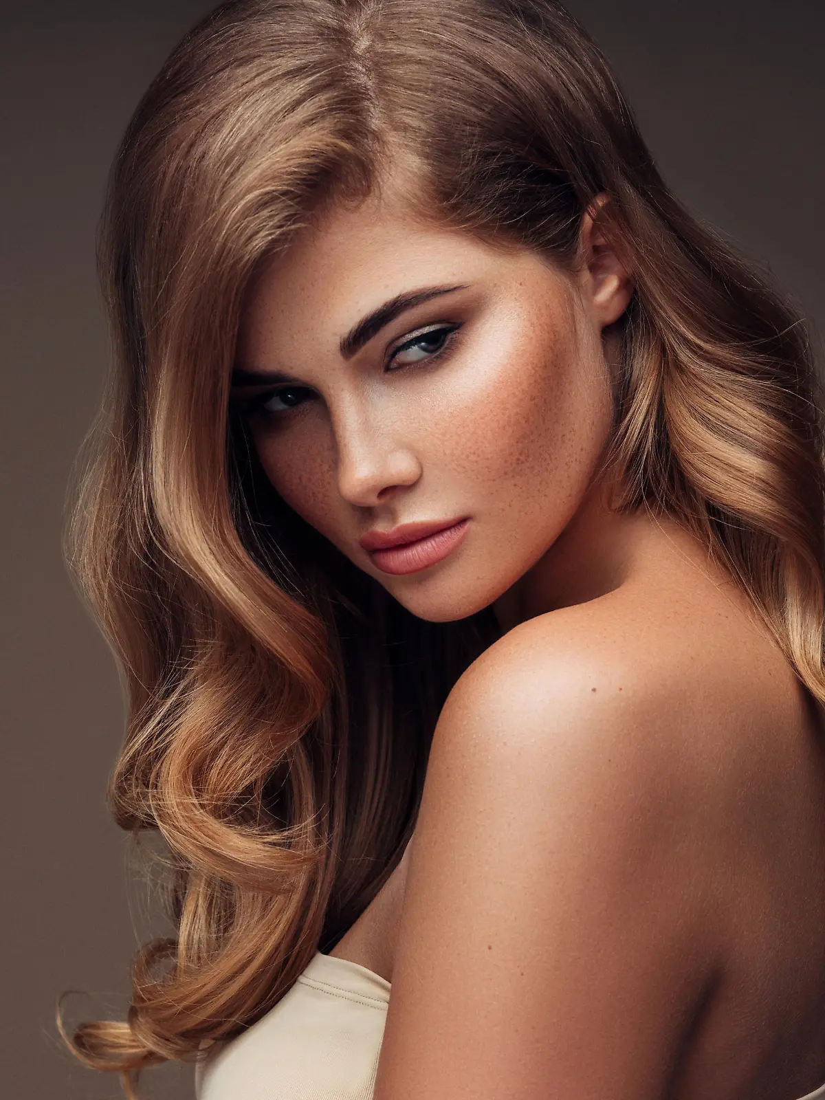 Young beautiful model with long wavy well groomed hair