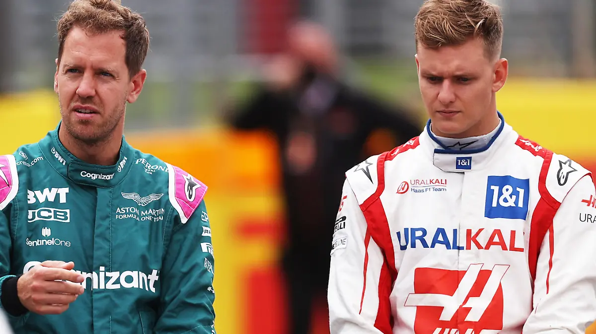 NORTHAMPTON, ENGLAND - JULY 15: Sebastian Vettel of Germany and Aston Martin F1 Team and Mick Schumacher of Germany and Haas F1 look on as the prototype for the 2022 F1 season is unveiled during previews ahead of the F1 Grand Prix of Great Britain at Silverstone on July 15, 2021 in Northampton, England. (Photo by Lars Baron/Getty Images)