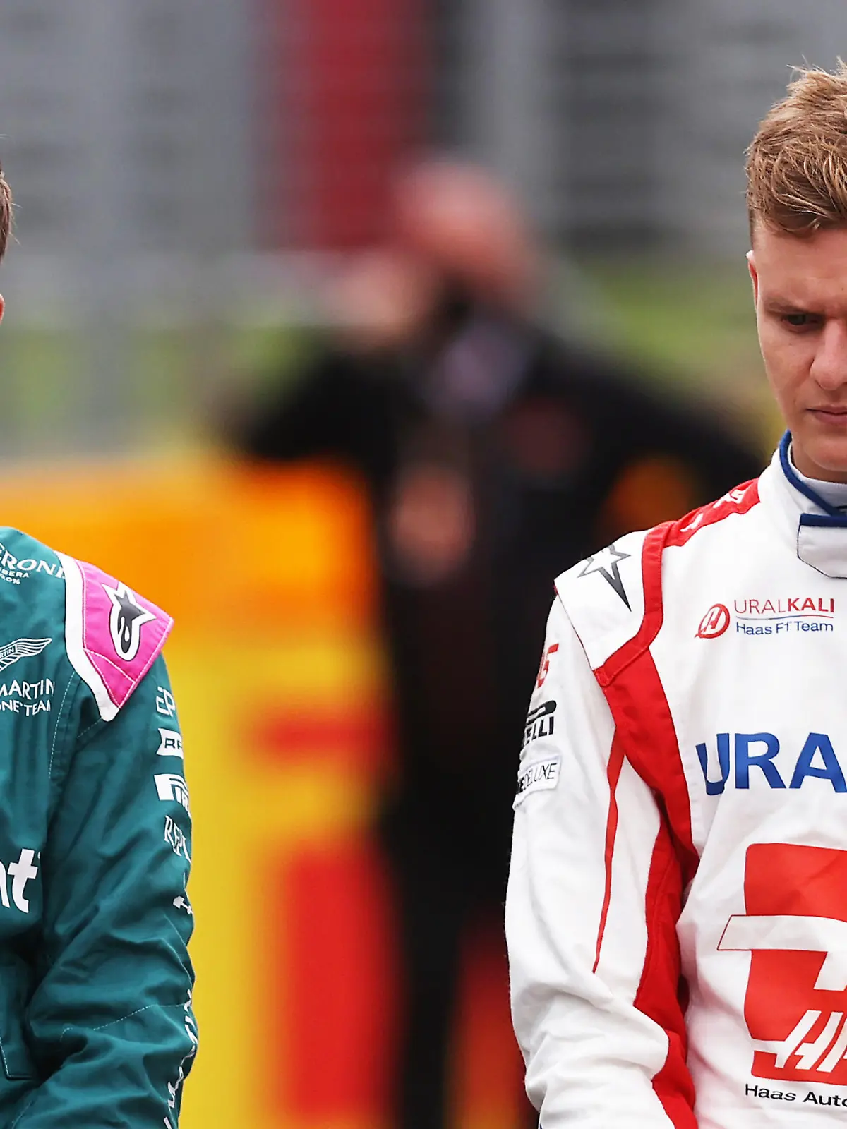 NORTHAMPTON, ENGLAND - JULY 15: Sebastian Vettel of Germany and Aston Martin F1 Team and Mick Schumacher of Germany and Haas F1 look on as the prototype for the 2022 F1 season is unveiled during previews ahead of the F1 Grand Prix of Great Britain at Silverstone on July 15, 2021 in Northampton, England. (Photo by Lars Baron/Getty Images)