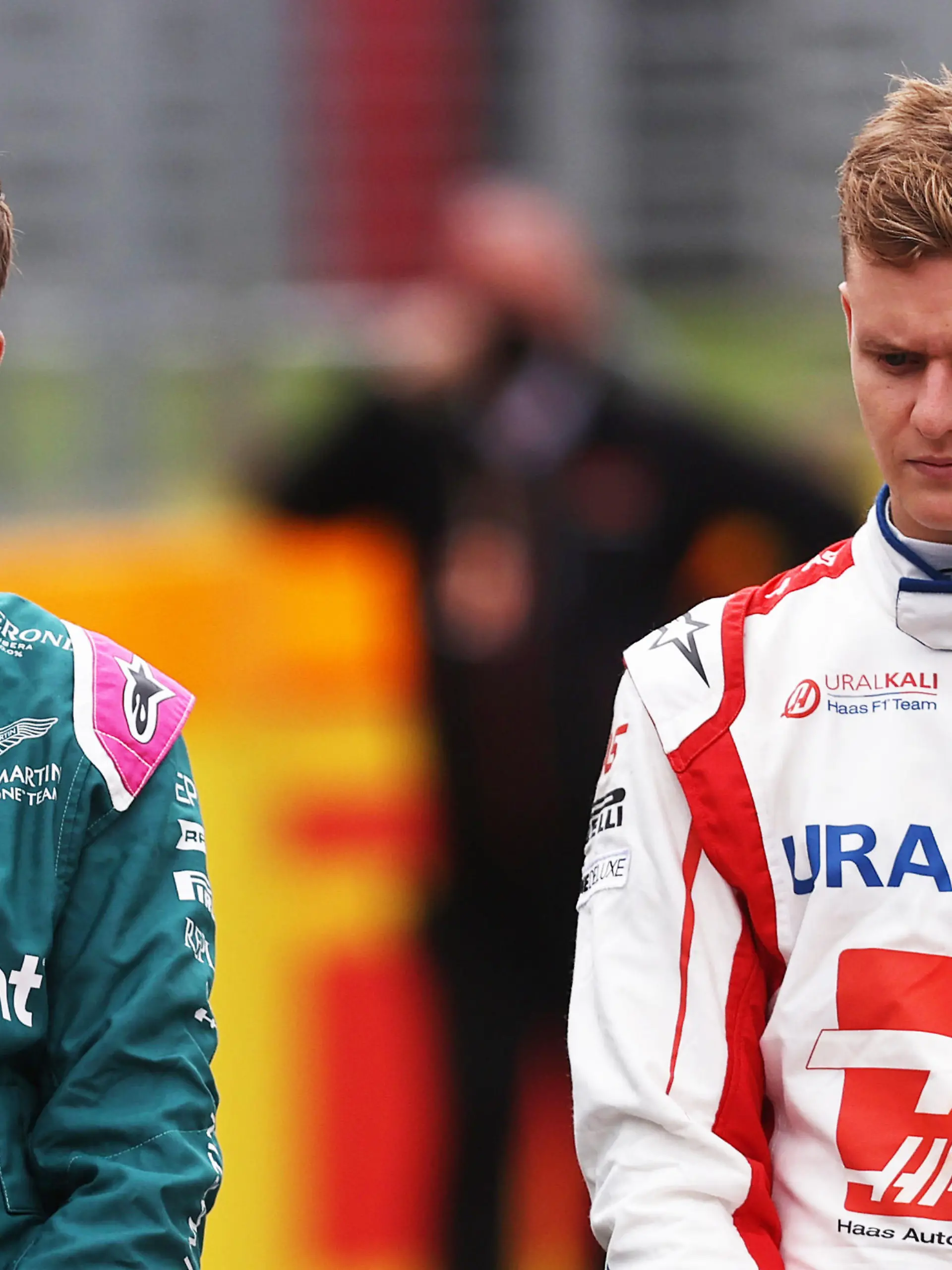 NORTHAMPTON, ENGLAND - JULY 15: Sebastian Vettel of Germany and Aston Martin F1 Team and Mick Schumacher of Germany and Haas F1 look on as the prototype for the 2022 F1 season is unveiled during previews ahead of the F1 Grand Prix of Great Britain at Silverstone on July 15, 2021 in Northampton, England. (Photo by Lars Baron/Getty Images)