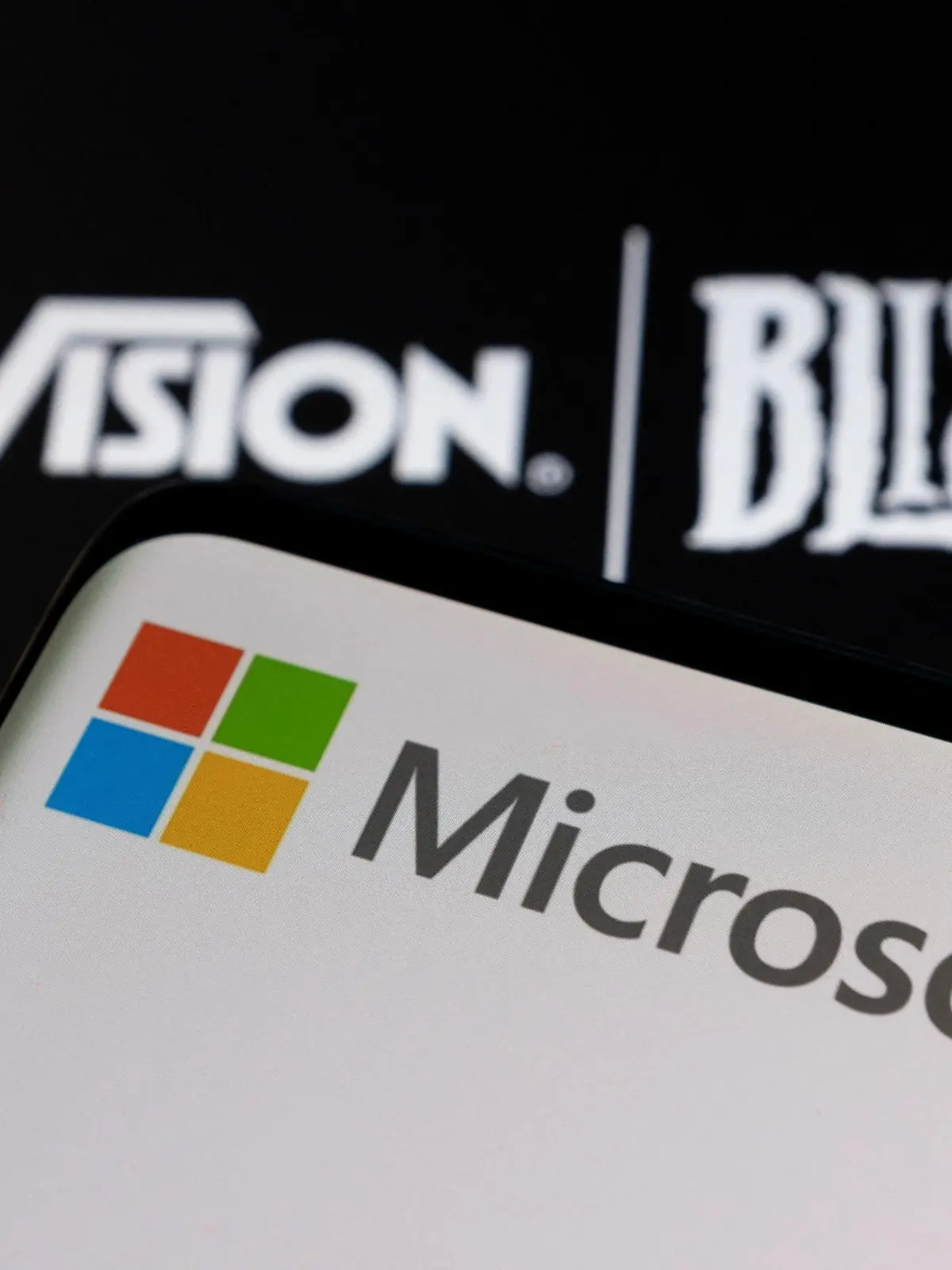 Microsoft logo is seen on a smartphone placed on displayed Activision Blizzard logo in this illustration taken January 18, 2022. REUTERS/Dado Ruvic/Illustration