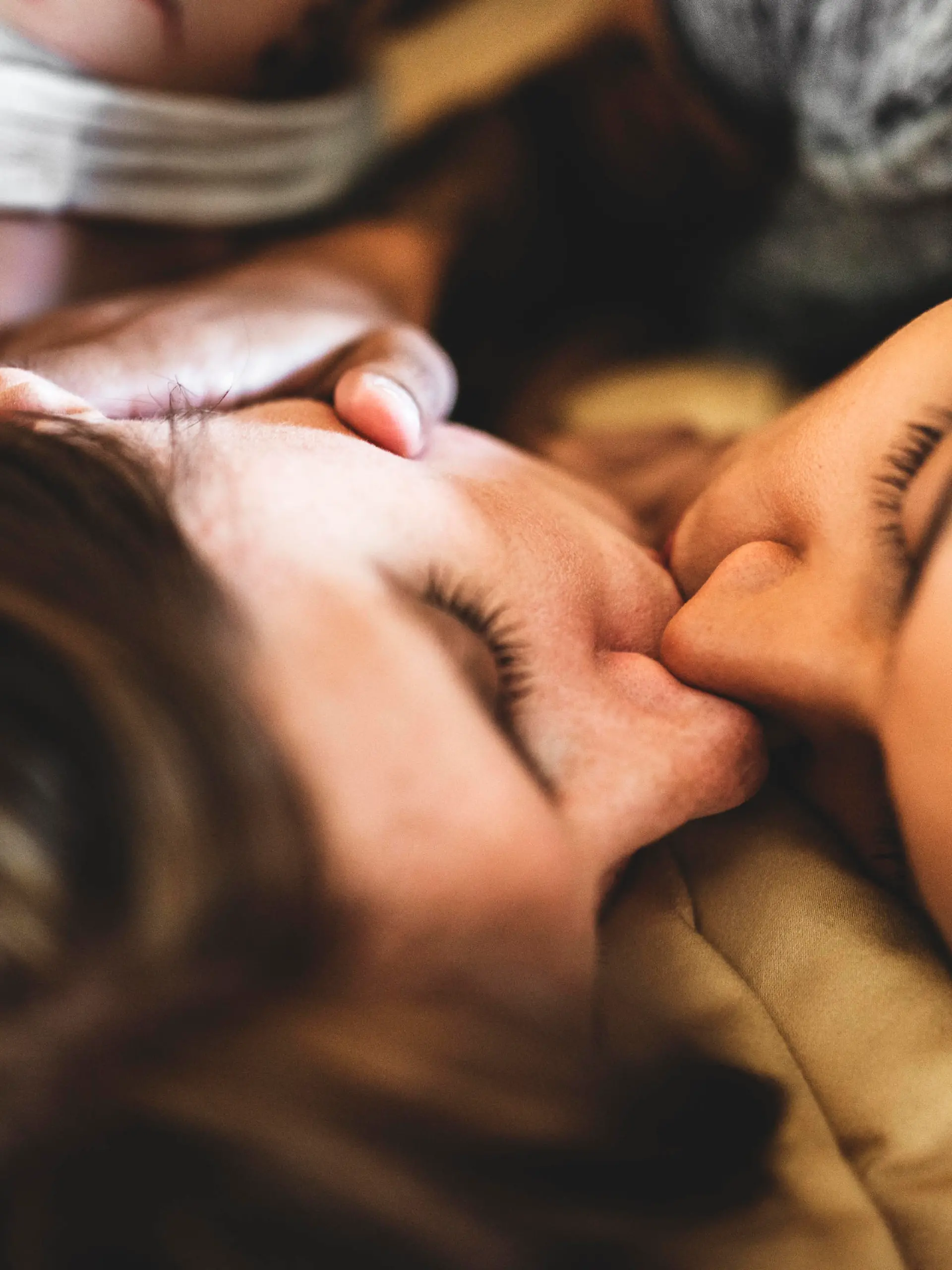 lesbian couple share the kiss on the bed