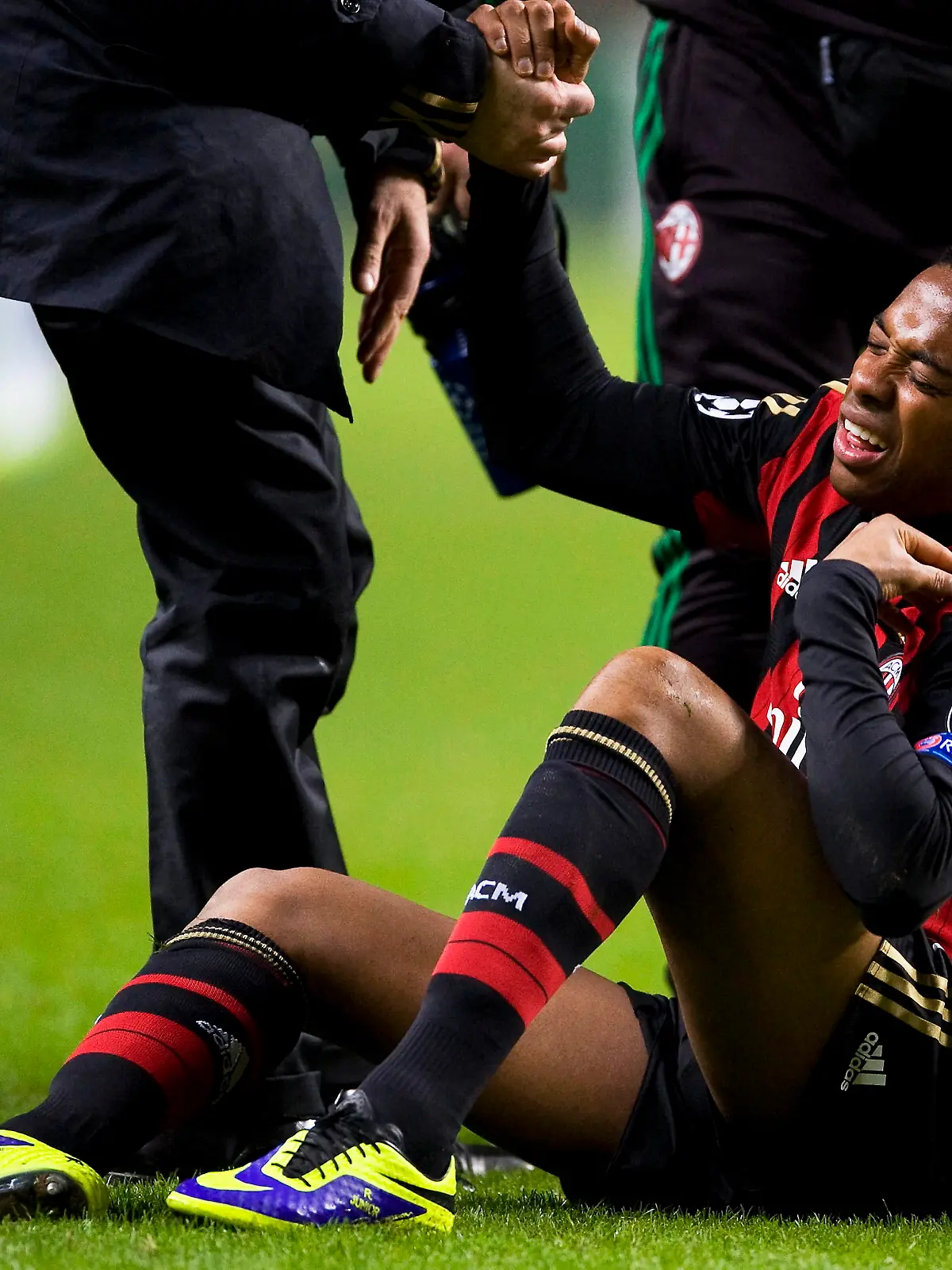 epa03966658 Milan's Robinho is helped following a tackle during the UEFA Champions League Group H soccer match between Celtic Glasgow and AC Milan at Celtic Park in Glasgow, Scotland, 26 November 2013. Milan won 3-0. EPA/BRIAN STEWART ++