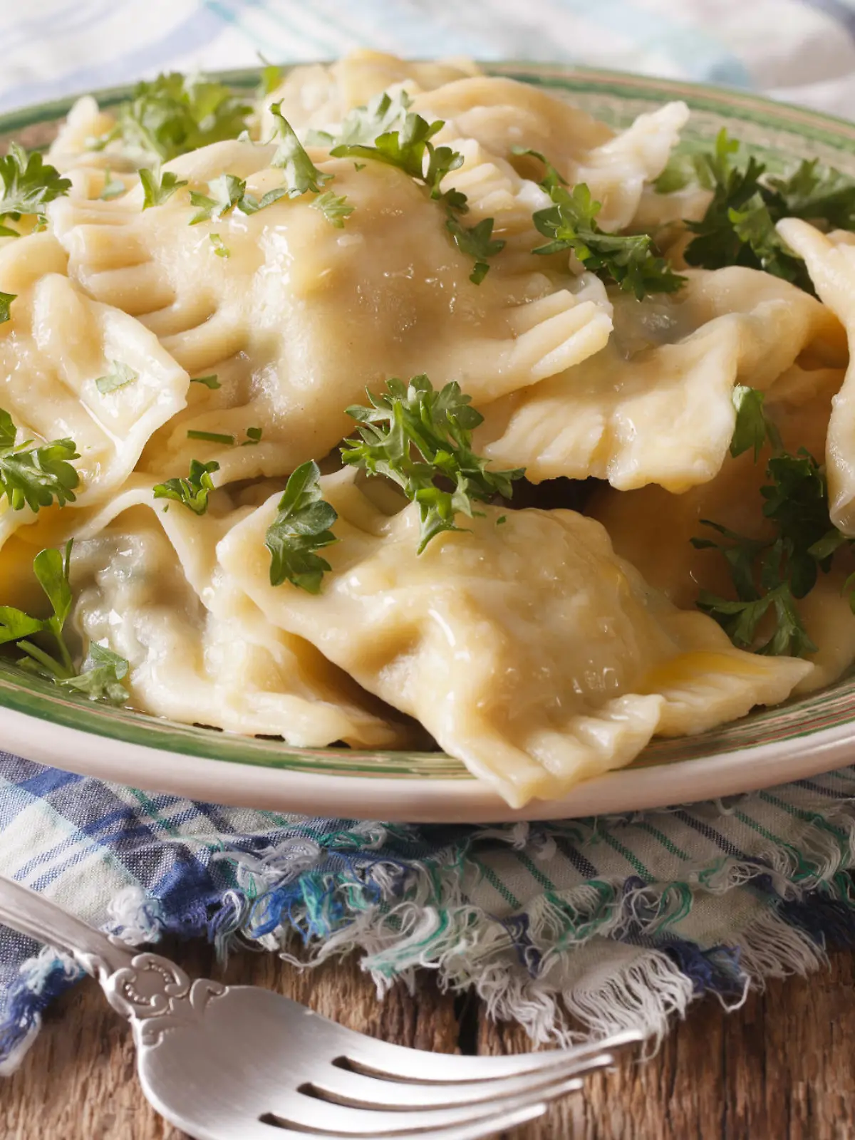 Swabian cuisine: Maultaschen dumplings stuffed with meat and spinach on a plate close-up. horizontal