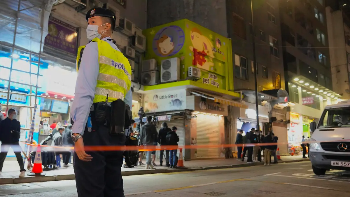 18.01.2022, China, Hong Kong: Ein Polizist steht vor einer Tierhandlung, die geschlossen wurde, nachdem einige Hamster positiv auf das Coronavirus getestet wurden. Im Zuge eines Corona-Ausbruchs haben die Behörden in Hongkong die Tötung von etwa 2000 Hamstern und anderen Kleintieren angeordnet. Foto: Kin Cheung/AP/dpa +++ dpa-Bildfunk +++