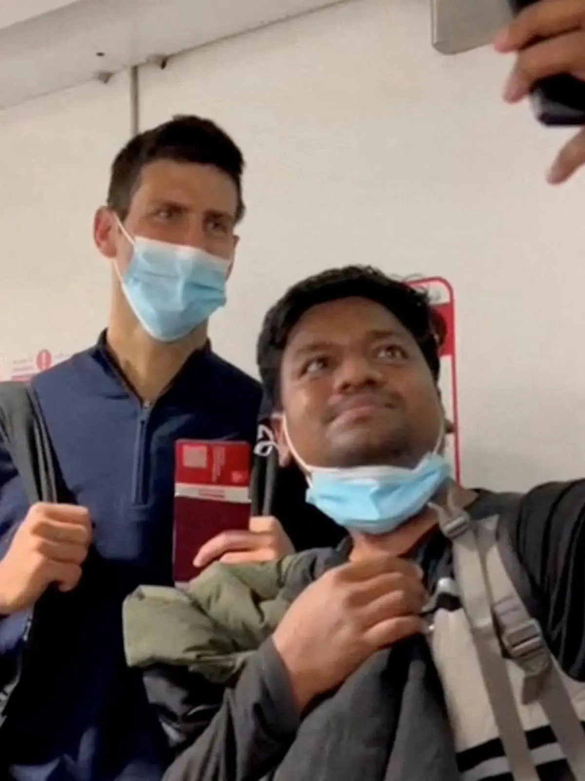Serbian tennis player Novak Djokovic poses for a selfie after landing at Dubai Airport after the Australian Federal Court upheld a government decision to cancel his visa to play in the Australian Open, in Dubai, United Arab Emirates, January 17, 2022, in this still image taken from video. REUTERS/Loren Elliott     TPX IMAGES OF THE DAY