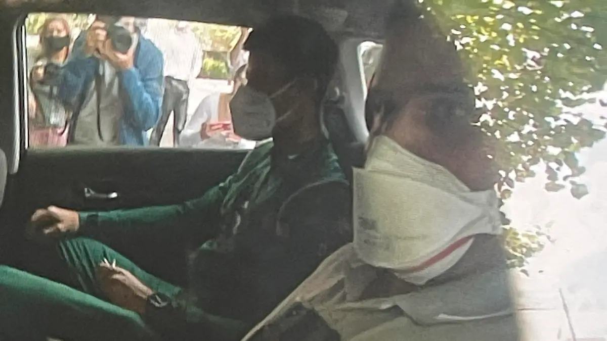 Novak Djokovic sits in the back of car arriving at an immigration detention hotel in Melbourne, Australia Saturday, Jan. 15, 2022. Djokovic was reported to be back in immigration detention Saturday after his legal challenge to avoid being deported from Australia for being unvaccinated for COVID-19 was moved to a higher court. (Channel 9 via AP)