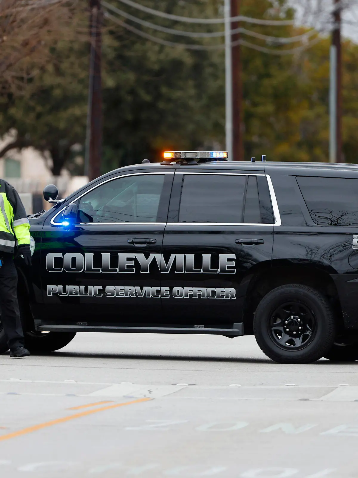 CORRECTS BYLINE TO ELIAS VALVERDE INSTEAD OF LYNDA M. GONZALEZ - A police officer blocks a street near Congregation Beth Israel in Colleyville, Texas on Saturday afternoon, Jan. 15, 2022. Authorities said a man took hostages Saturday during services at the synagogue where the suspect could be heard ranting in a livestream and demanding the release of a Pakistani neuroscientist who was convicted of trying to kill U.S. Army officers in Afghanistan. (Elias Valverde/The Dallas Morning News via AP)