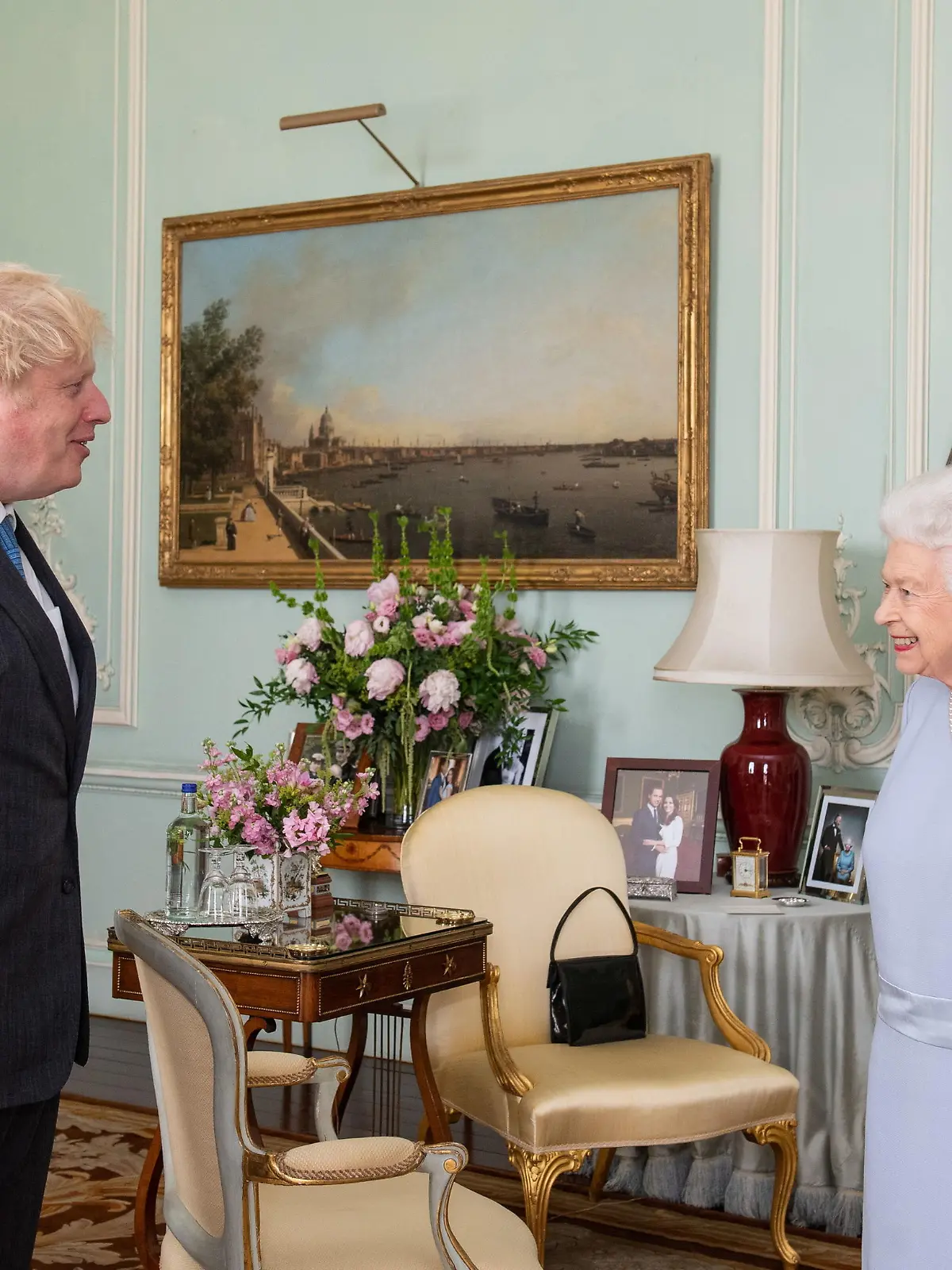 Britain's Queen Elizabeth II greets Prime Minister Boris Johnson at the first in-person weekly audience with the Prime Minister since the start of the coronavirus pandemic, at Buckingham Palace in London, Briain June 23, 2021. Dominic Lipinski/Pool via REUTERS