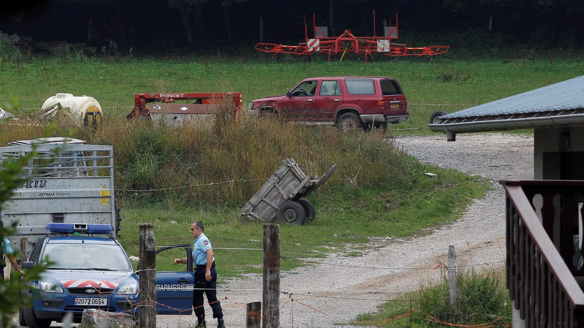 epa03384933 French Police officers cordon off the road leading to the scene where four people died in a shooting at a parking in Chevaline near the Annecy Lake, France, 05 September 2012. The bodies of four people who had been shot dead were found in the French Alps, prosecutors said late 05 September, while a young girl survived the attack and was in a critical condition. The bodies of a man and two women were found by a cyclist in a British-registered car in a secluded car park near Lake Annecy. The girl and the body of a male cyclist were found nearby. All had gun shot wounds. EPA/NORBERT FALCO/LE DAUPHINE FRANCE OUT +++(c) dpa - Bildfunk+++