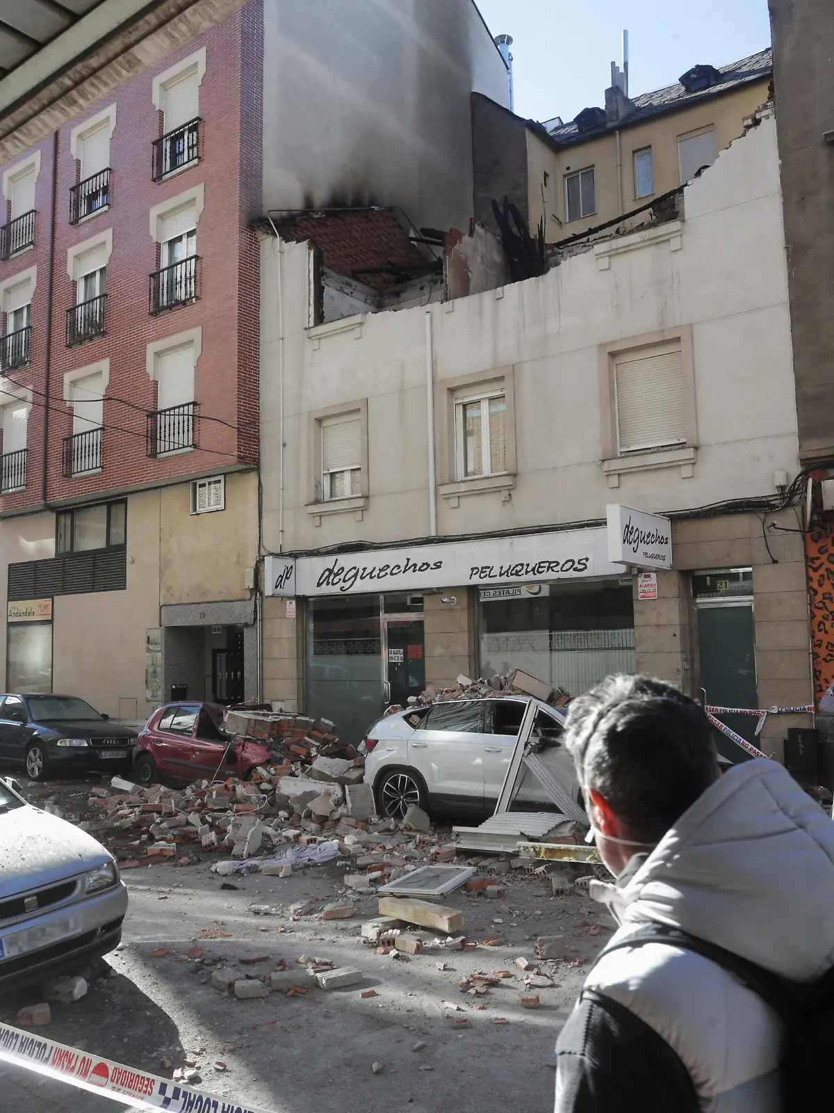 PONFERRADA, LEON, CASTILLA Y LEO, SPAIN - JANUARY 13: Two people look at the burnt house and the damage caused by an explosion, in Alcon street, on 13 January, 2022 in Ponferrada, Leon, Castilla y Leon, Spain. A two-story single-family dwelling located on Calle Alcon in Ponferrada has been set on fire after a 36-year-old man who was going to be evicted from this residence caused a gas explosion in the property. The 36 year-old man turned himself in to the Ponferrada police station hours after the incident. The Scientific Police of the locality has gone to the house to clarify the causes of the fire, in which there have been no personal injuries. (Photo By Carlos Castro/Europa Press via Getty Images)