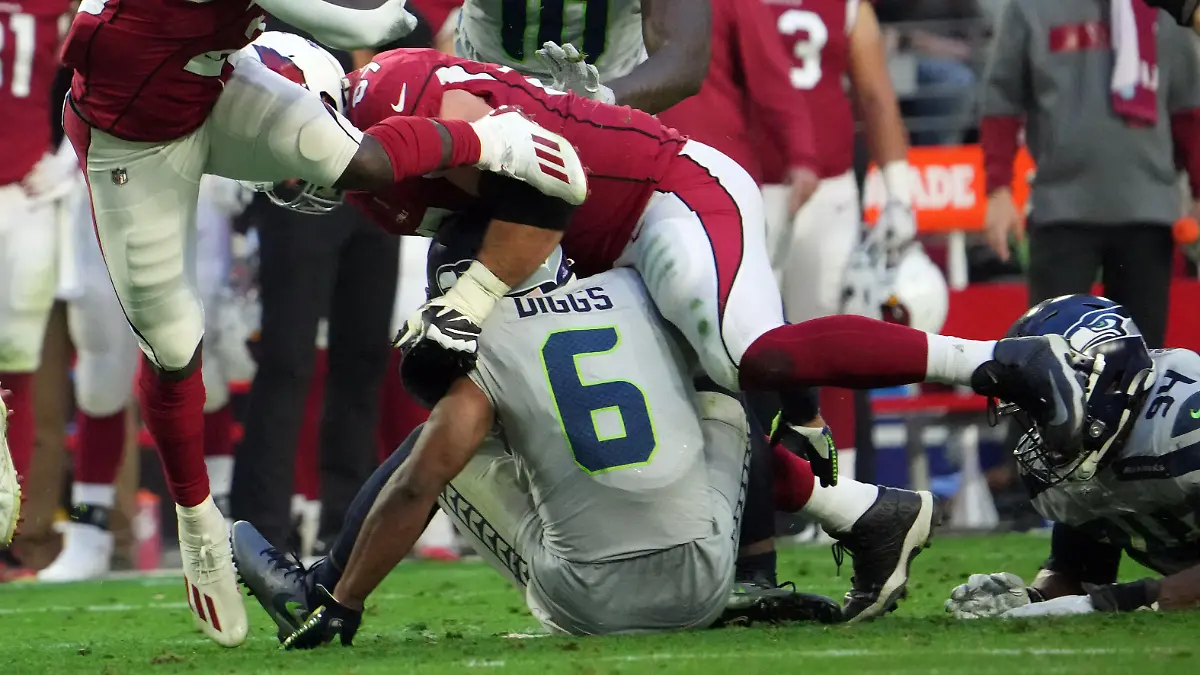 Jan 9, 2022; Glendale, Arizona, USA; Seattle Seahawks free safety Quandre Diggs (6) injures his leg as he tackles Arizona Cardinals running back Eno Benjamin (26) during the second half at State Farm Stadium. Mandatory Credit: Joe Camporeale-USA TODAY Sports