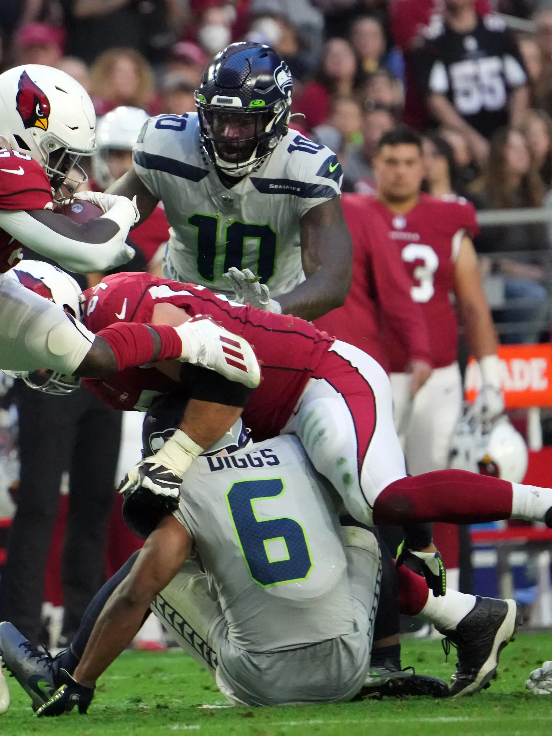 Jan 9, 2022; Glendale, Arizona, USA; Seattle Seahawks free safety Quandre Diggs (6) injures his leg as he tackles Arizona Cardinals running back Eno Benjamin (26) during the second half at State Farm Stadium. Mandatory Credit: Joe Camporeale-USA TODAY Sports