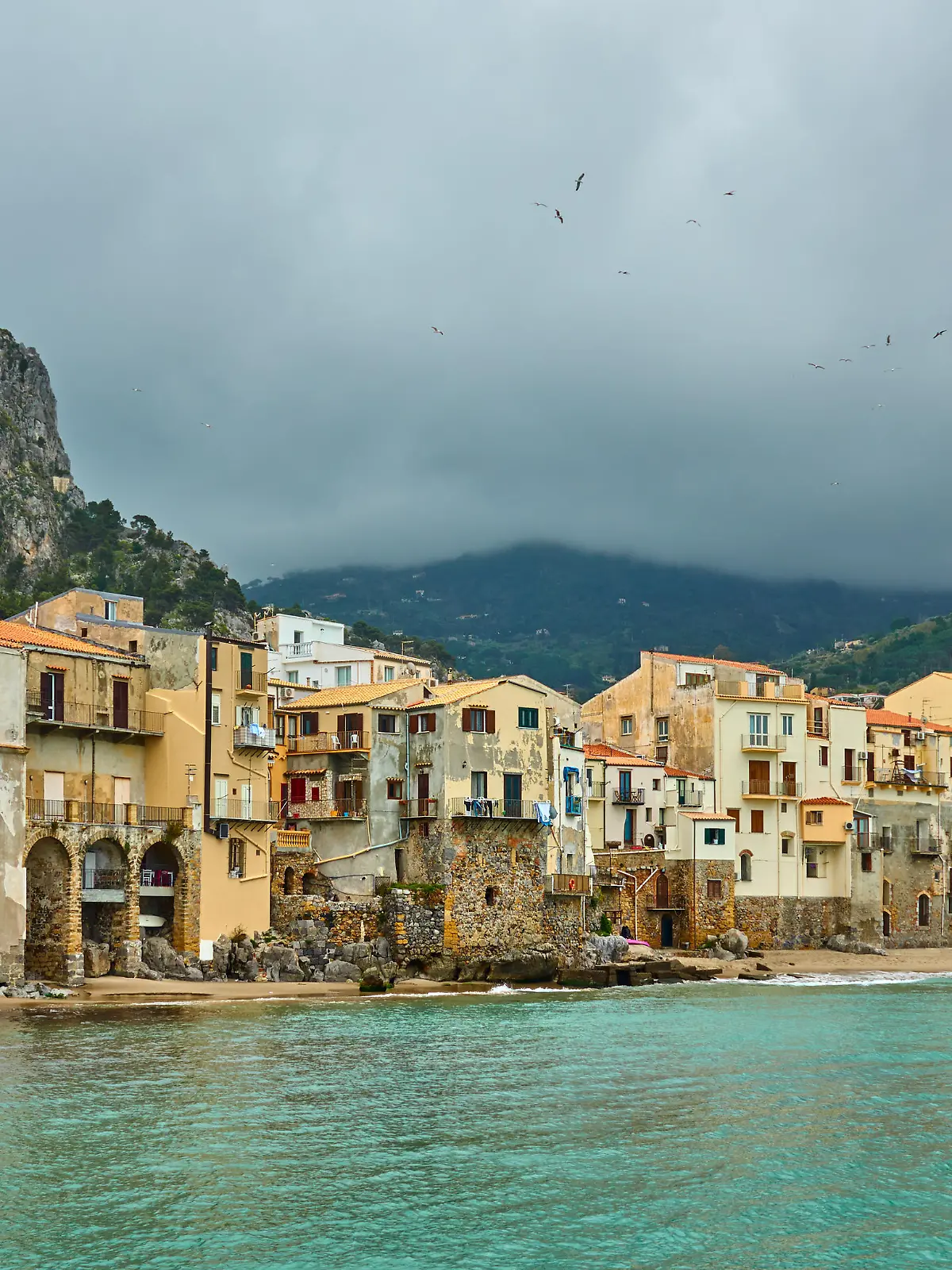 Colorful old houses by the sea in Cefalu in Sicily, Italy