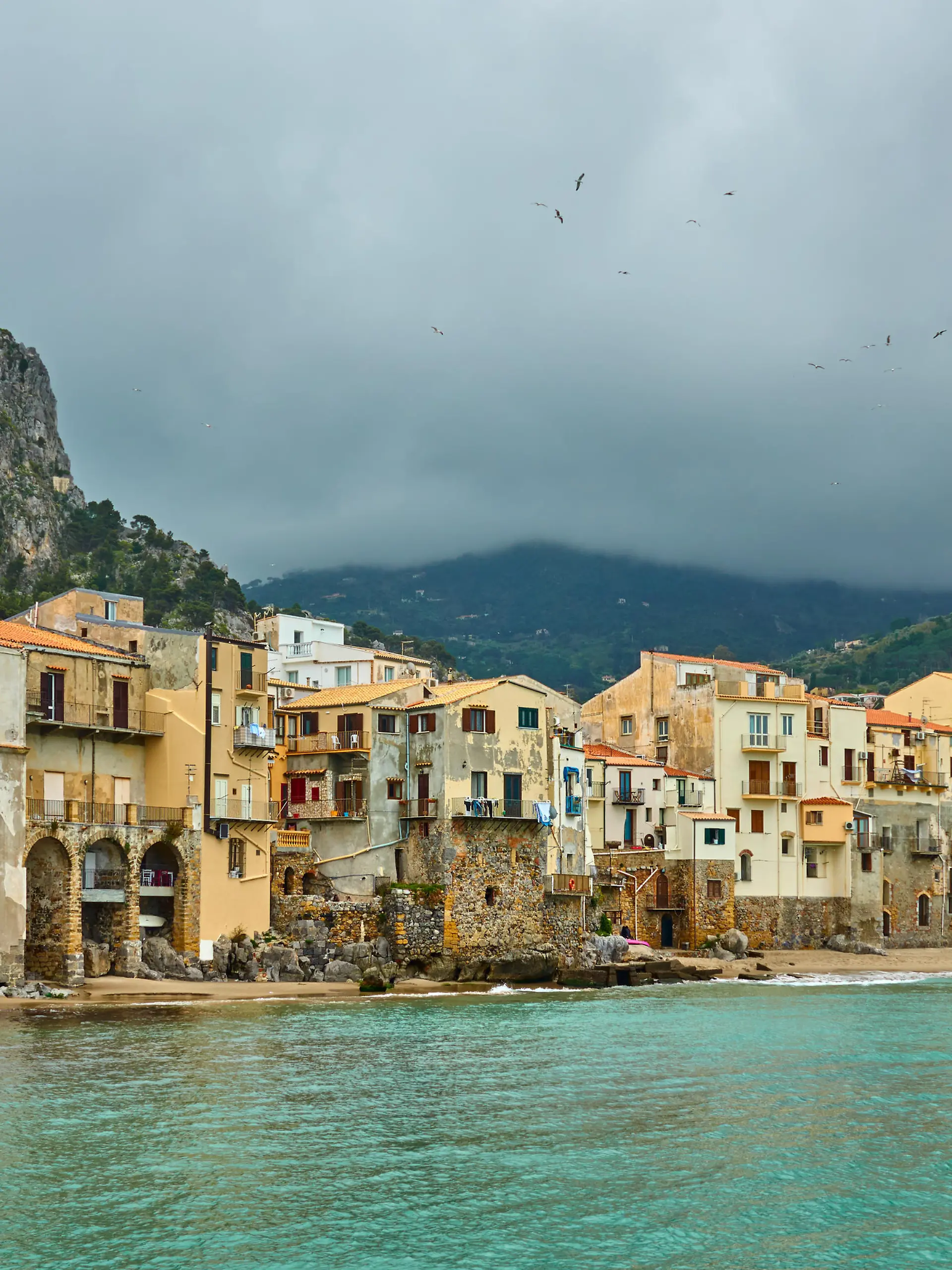 Colorful old houses by the sea in Cefalu in Sicily, Italy