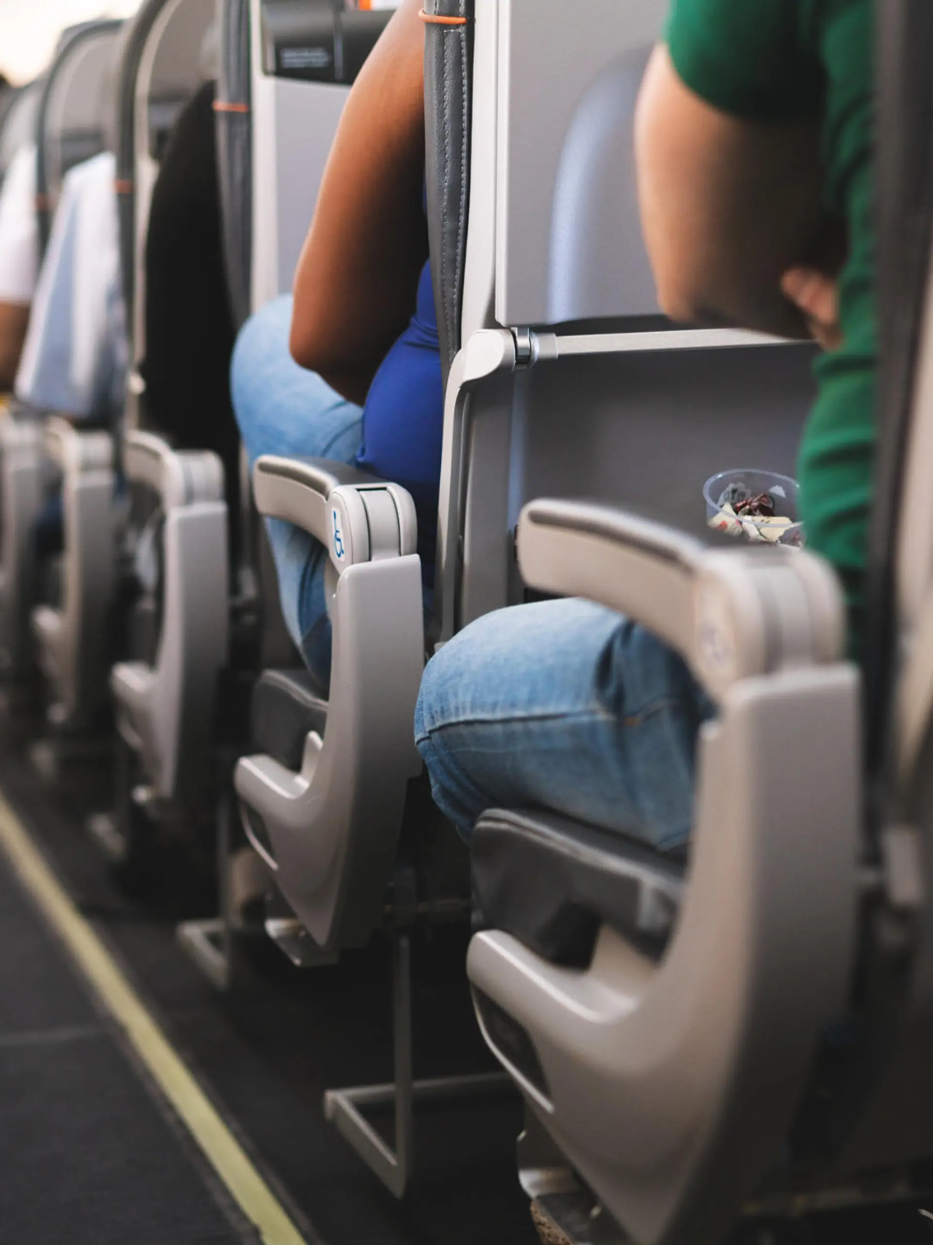 Ein Gang im Flugzeug mit Sitzen und Passagieren