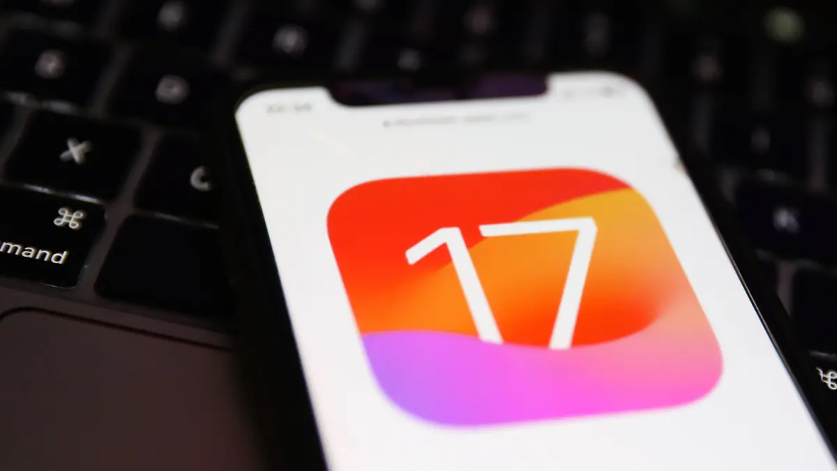 A laptop keyboard and Apple iOS 17 logo on a website displayed on a phone screen are seen in this illustration photo taken in Krakow, Poland on June 6, 2023. (Photo by Jakub Porzycki/NurPhoto)