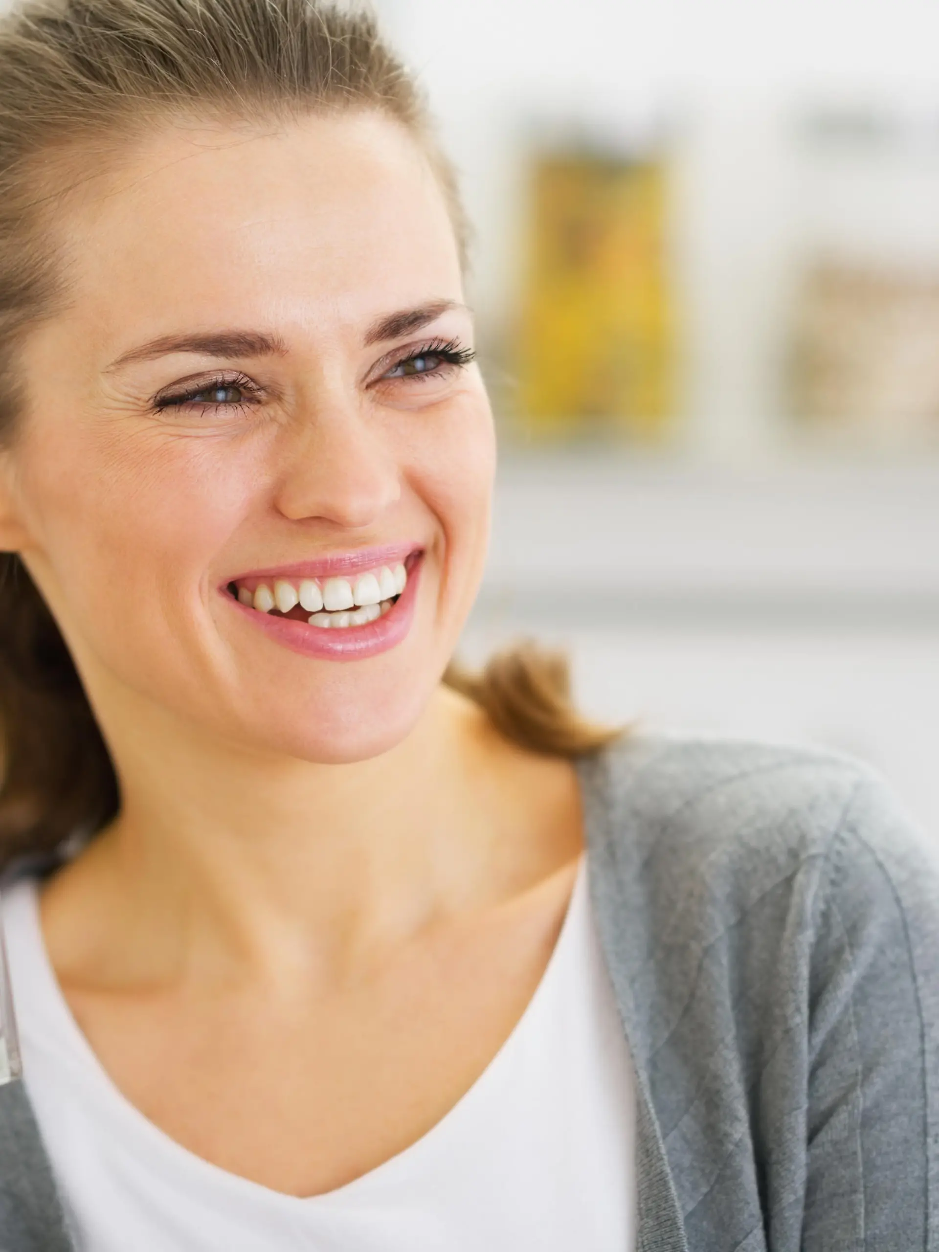 Smiling young woman drinking fresh cocktail
