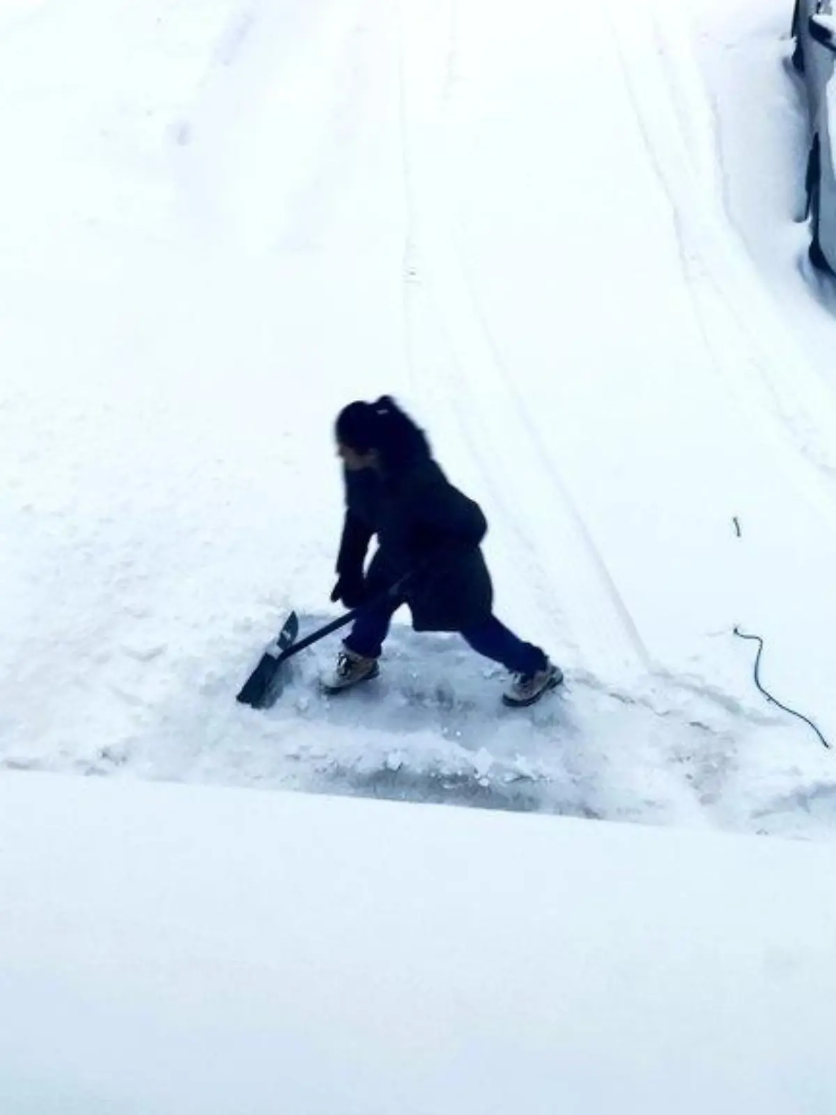 Frau schippt Schnee