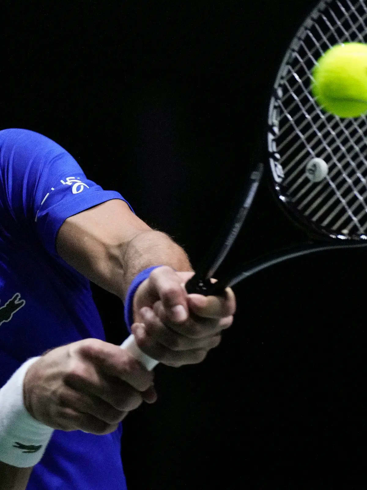 FILE - Serbia's Novak Djokovic returns the ball to Croatia's Marin Cilic during their Davis Cup tennis semi-final match at Madrid Arena in Madrid, Spain, Friday, Dec. 3, 2021. An Australian judge reinstated tennis star Novak Djokovic's visa Monday, Jan. 10, 2022, which was canceled last week because he is unvaccinated. (AP Photo/Bernat Armangue, File)