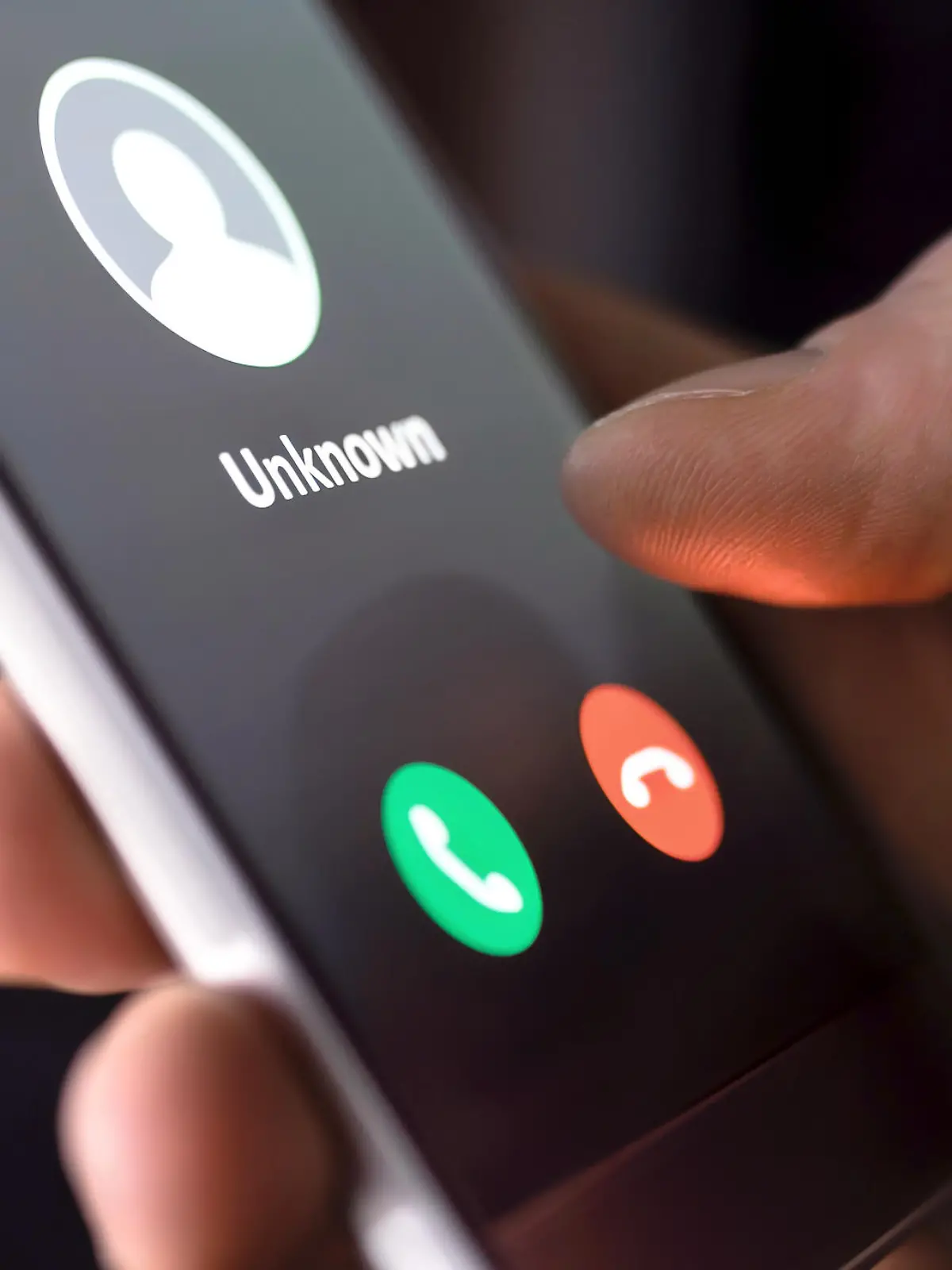 Phone call from unknown number late at night. Scam, fraud or phishing with smartphone concept. Prank caller, scammer or stranger. Man answering to incoming call. Hoax person with fake identity.