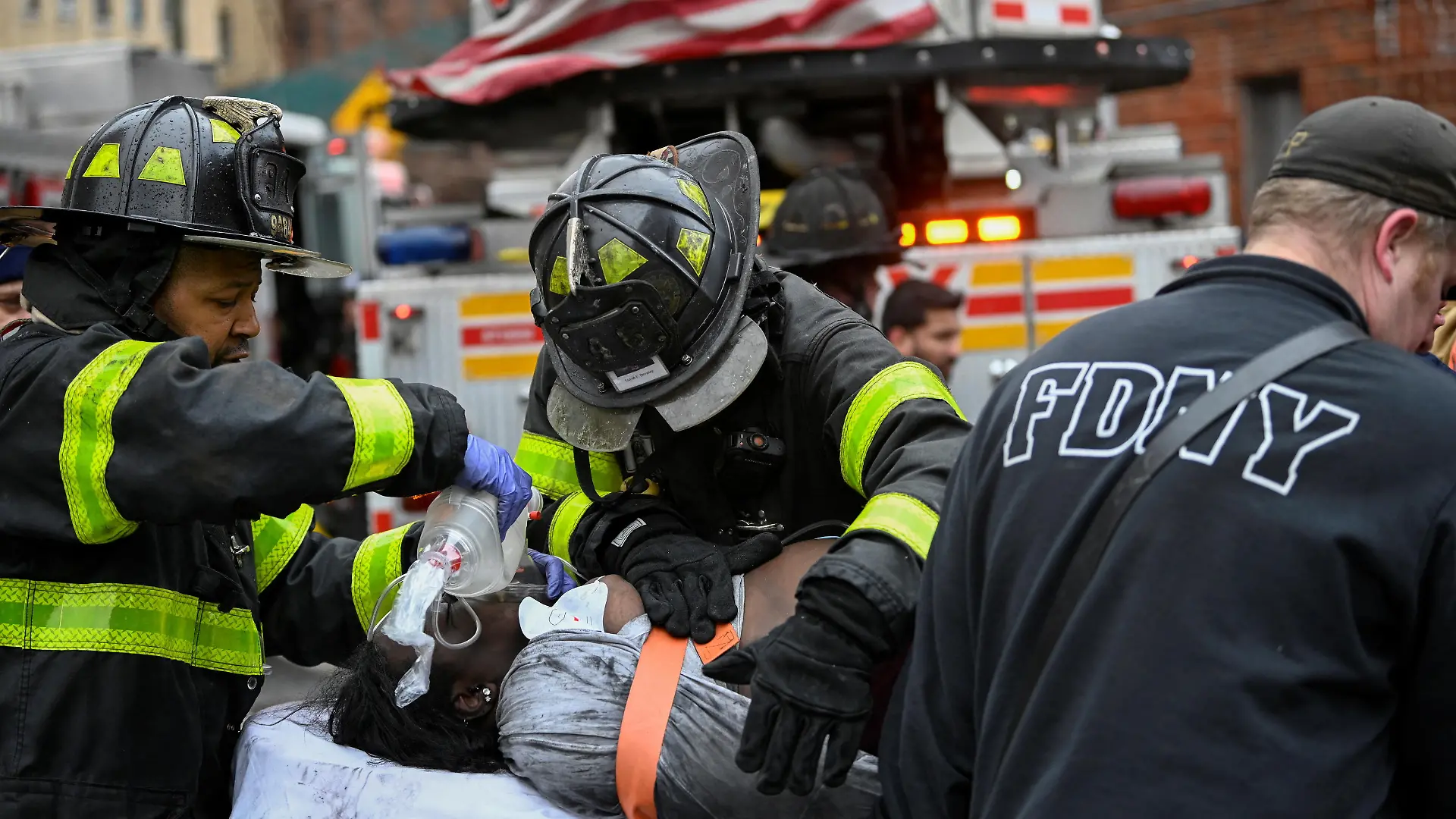 Emergency personnel from the FDNY provide medical aid as they respond to an apartment building fire in the Bronx borough of New York City, U.S., January 9, 2022. REUTERS/Lloyd Mitchell