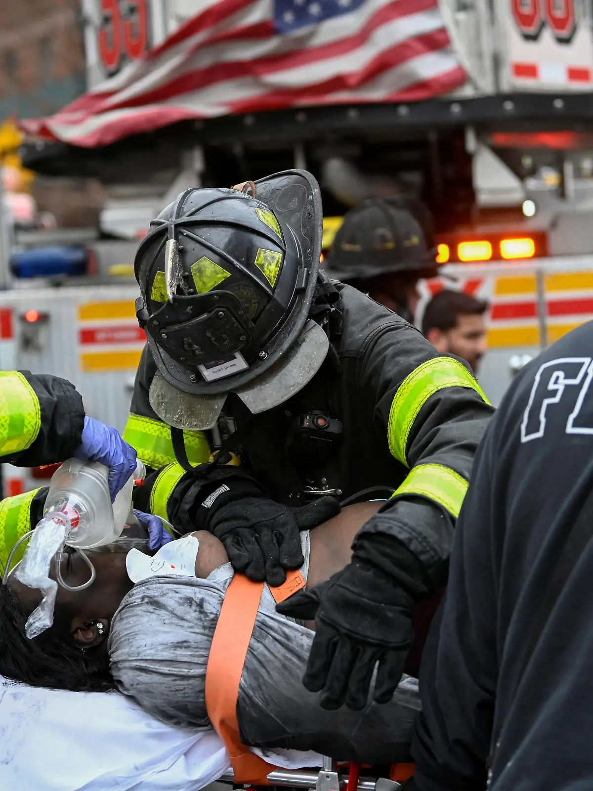 Emergency personnel from the FDNY provide medical aid as they respond to an apartment building fire in the Bronx borough of New York City, U.S., January 9, 2022.  REUTERS/Lloyd Mitchell