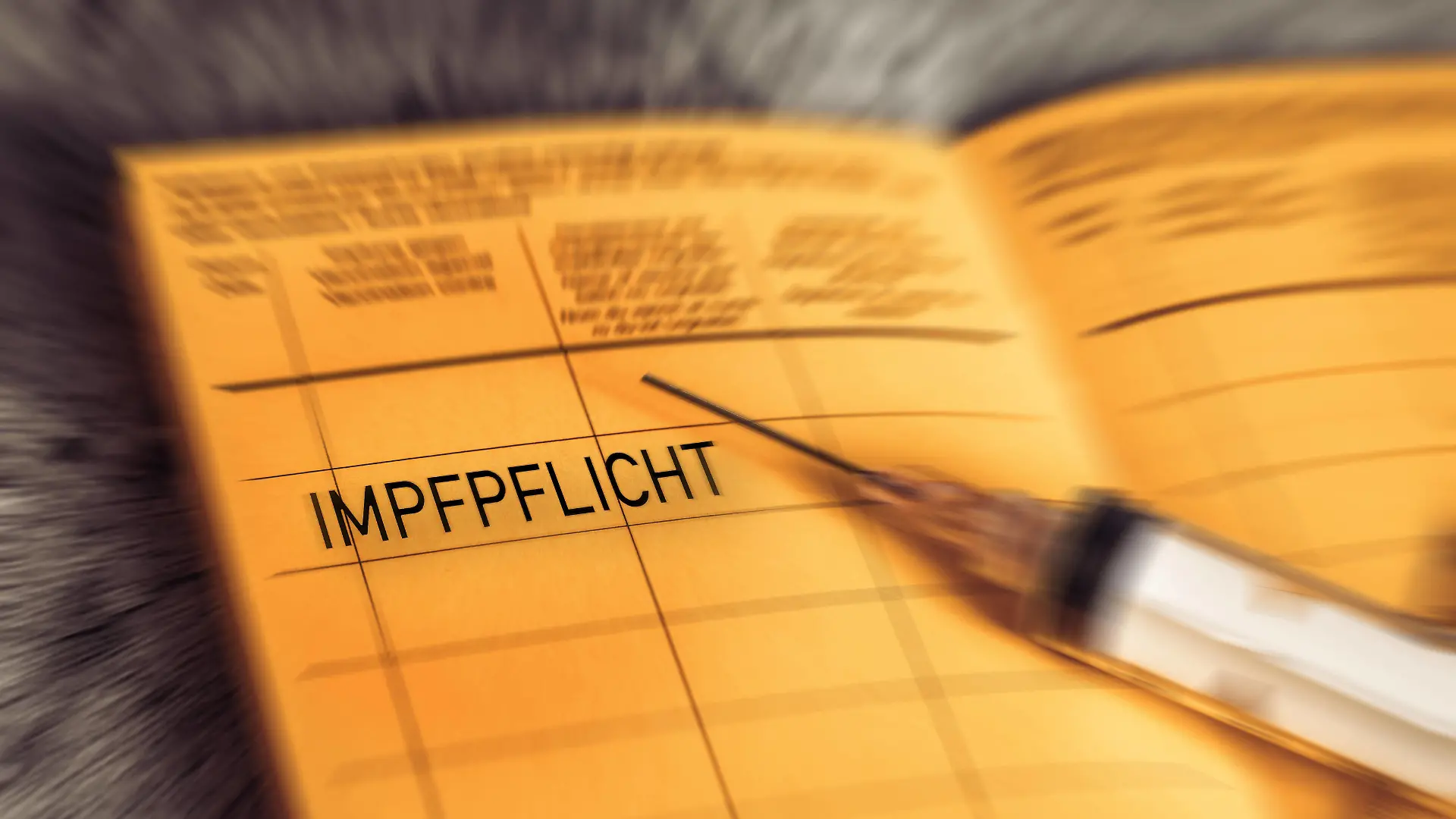 27 December 2021: Impfpflicht - vaccination book with the imprint Compulsory vaccination, symbol image for a General Covid-19 coronavirus Compulsory vaccination, yellow vaccination card *** Impfpflicht - Impfbuch mit dem Aufdruck Impfpflicht, Symbolbild für eine Allgemeine Covid-19 Coronavirus Pflicht zur Impfung, gelber Impfpass xFOTOMONTAGEx