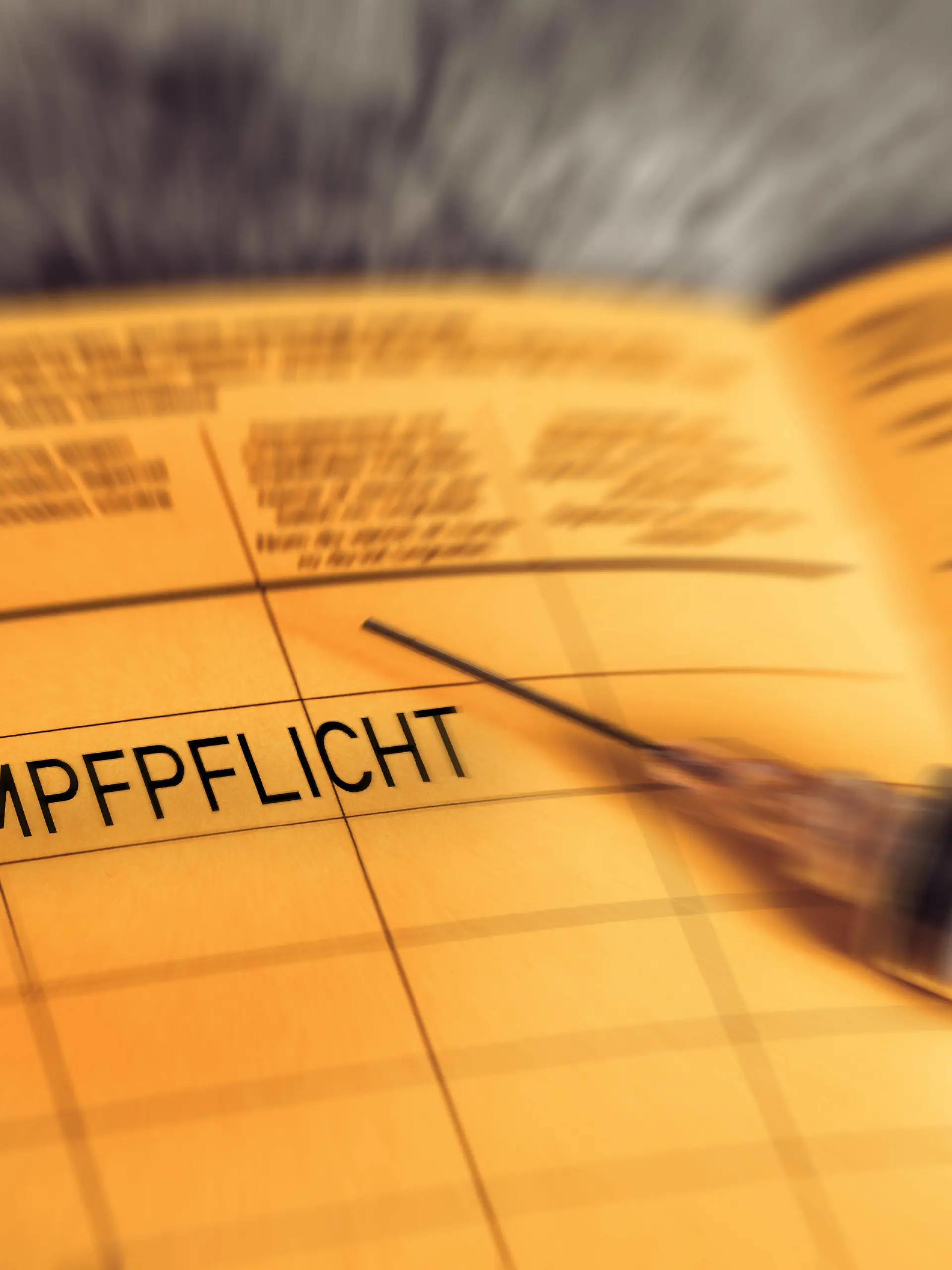  27 December 2021: Impfpflicht - vaccination book with the imprint Compulsory vaccination, symbol image for a General Covid-19 coronavirus Compulsory vaccination, yellow vaccination card *** Impfpflicht - Impfbuch mit dem Aufdruck Impfpflicht, Symbolbild für eine Allgemeine Covid-19 Coronavirus Pflicht zur Impfung, gelber Impfpass xFOTOMONTAGEx