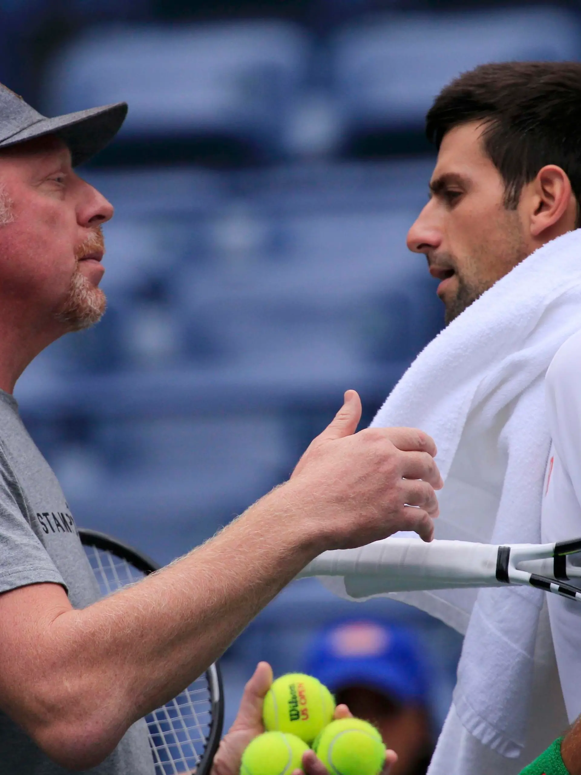 Tennis coach Boris Becker talks with Novak Djokovic of Serbia during a practice session on center court for the upcoming U.S. Open men's singles final match at the U.S. Open Championships tennis tournament in New York, September 12, 2015. Djokovic faces Roger Federer of Switzerland on September 13.  REUTERS/Eduardo Munoz