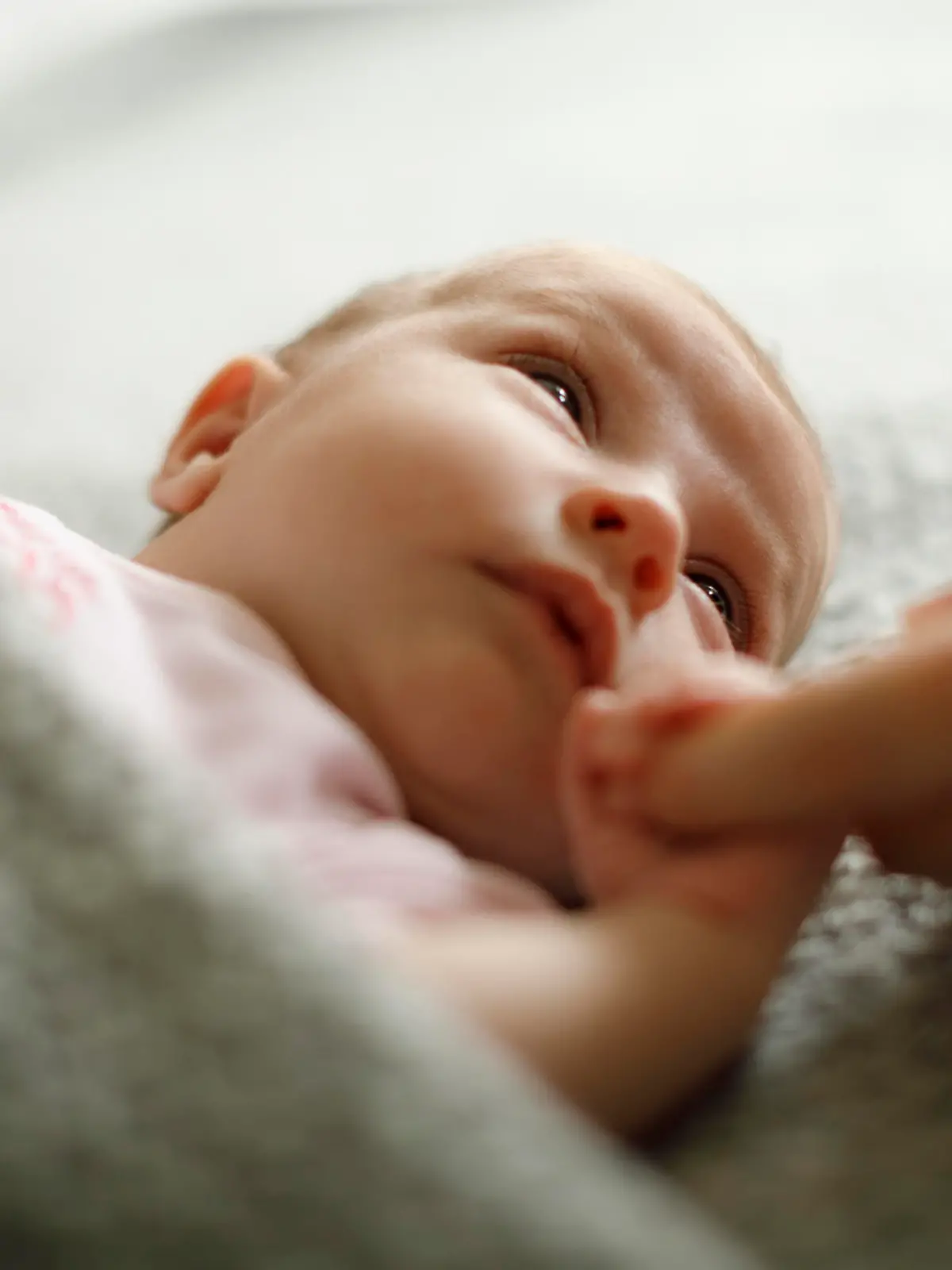 Newborn baby holding mother's hand
