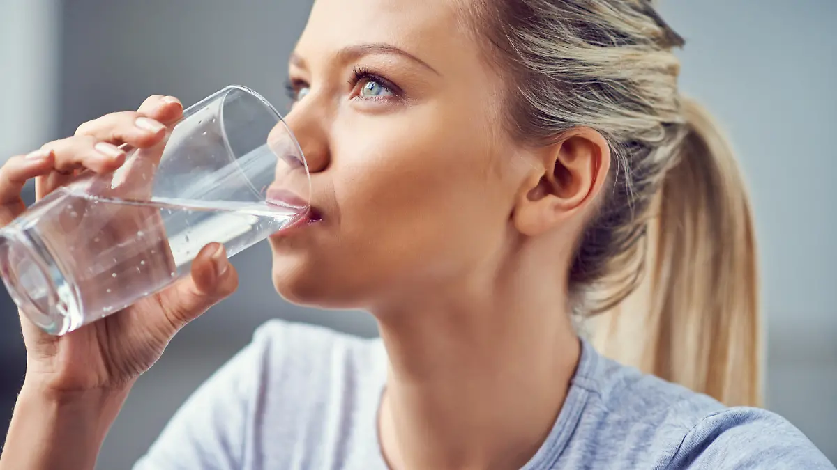 Young woman drinking purified water